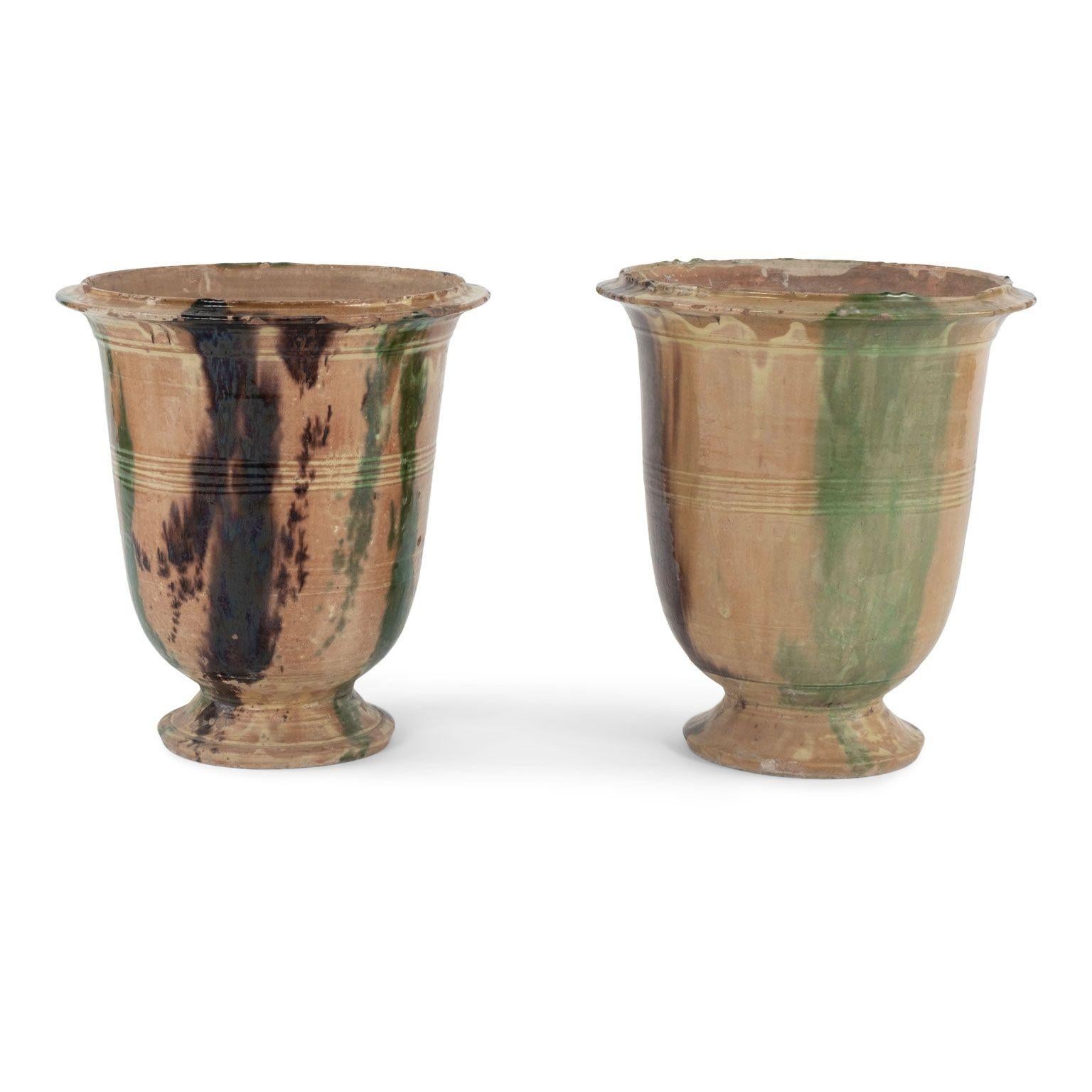 Pair of Petite Anduze jars in tricolor brown, green and yellow glaze, circa 1900-1939. Suitable for outdoor use, or indoors on floor or table top.
1st jar measures 16.75 inches high x 15.25 inches diameter
2nd jar measures: 16.5 inches high x 15