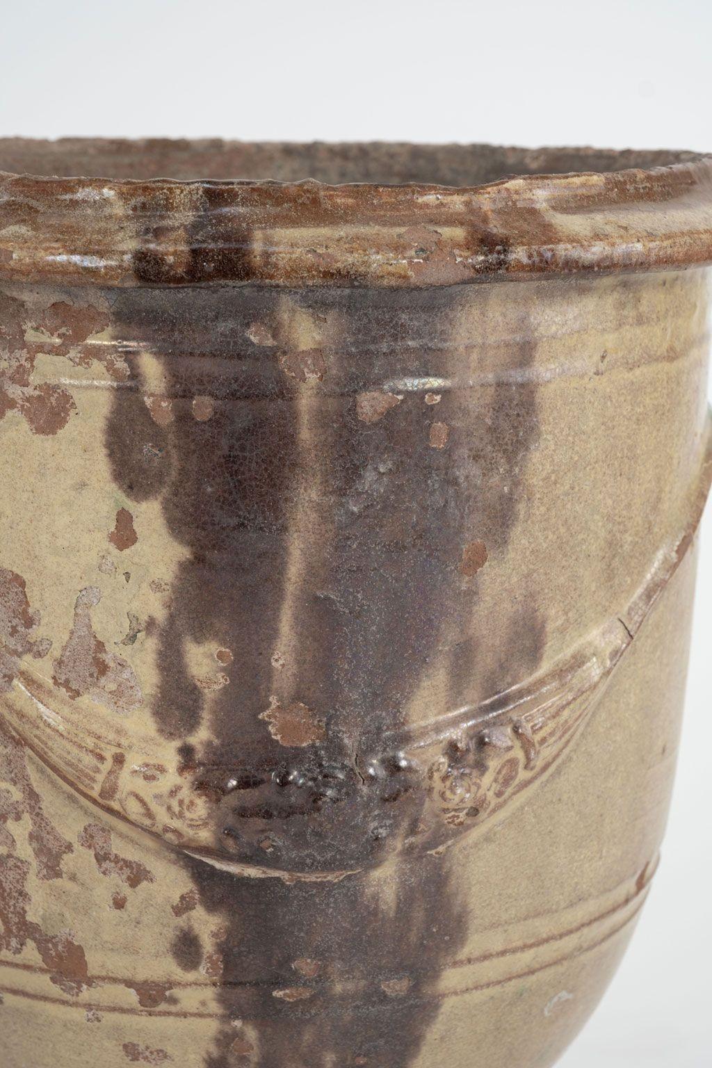 Pair of Petite Anduze jars in tricolor brown, green and yellow glaze. Hand-made circa 1910-1949 by the Boisset Poterie. Beautiful color and patina from decades of natural wear and use. Perfect size for table tops. Some chips and flaking around edges