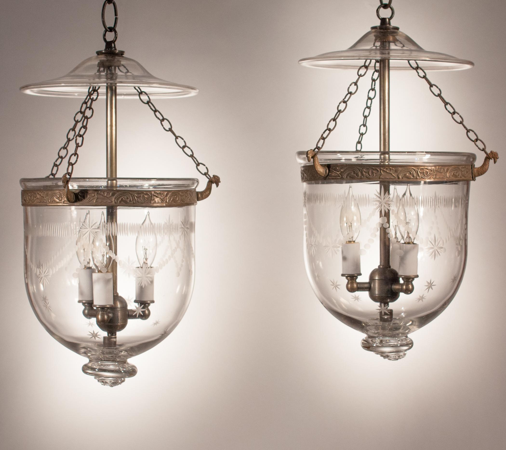 An exceptional pair of antique bell jar lanterns with a Federal-style etching. From smoke bell to glass pontil, it is rare to find a set of bell jars that it is this well-matched and possesses such outstanding quality handblown glass. These petite