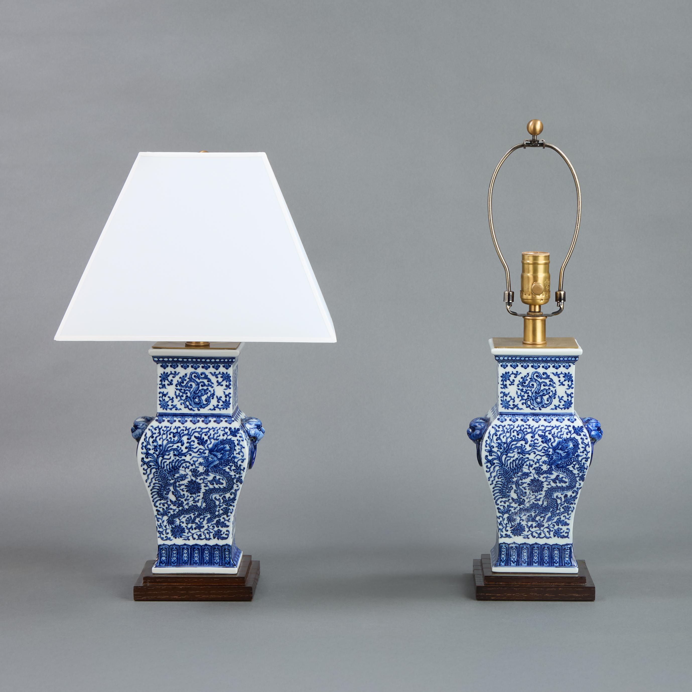 Pair of Petite Chinese Blue and White Lamps.
Lotus, Dragon and Phoenix pattern.
11″ to top of vase. 20.5″ h to shade rest.
5.25″ x 4.5″ base.