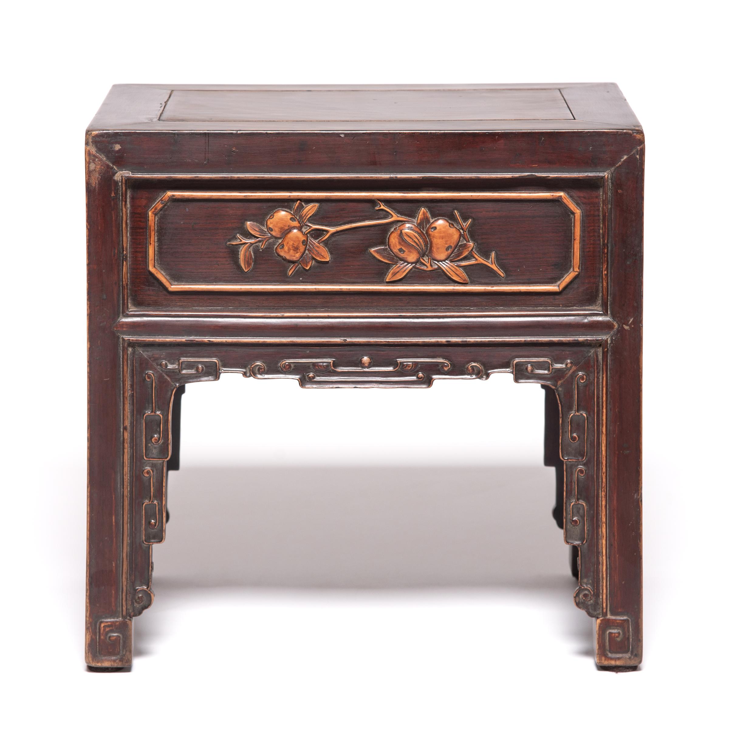 Created by a Qing-dynasty artisan over 150 years ago, these petite tables with boxwood inlay of auspicious fruit and floral arrangements were likely used as display stands for figures, vases, and other precious objects. Appreciated for its smooth