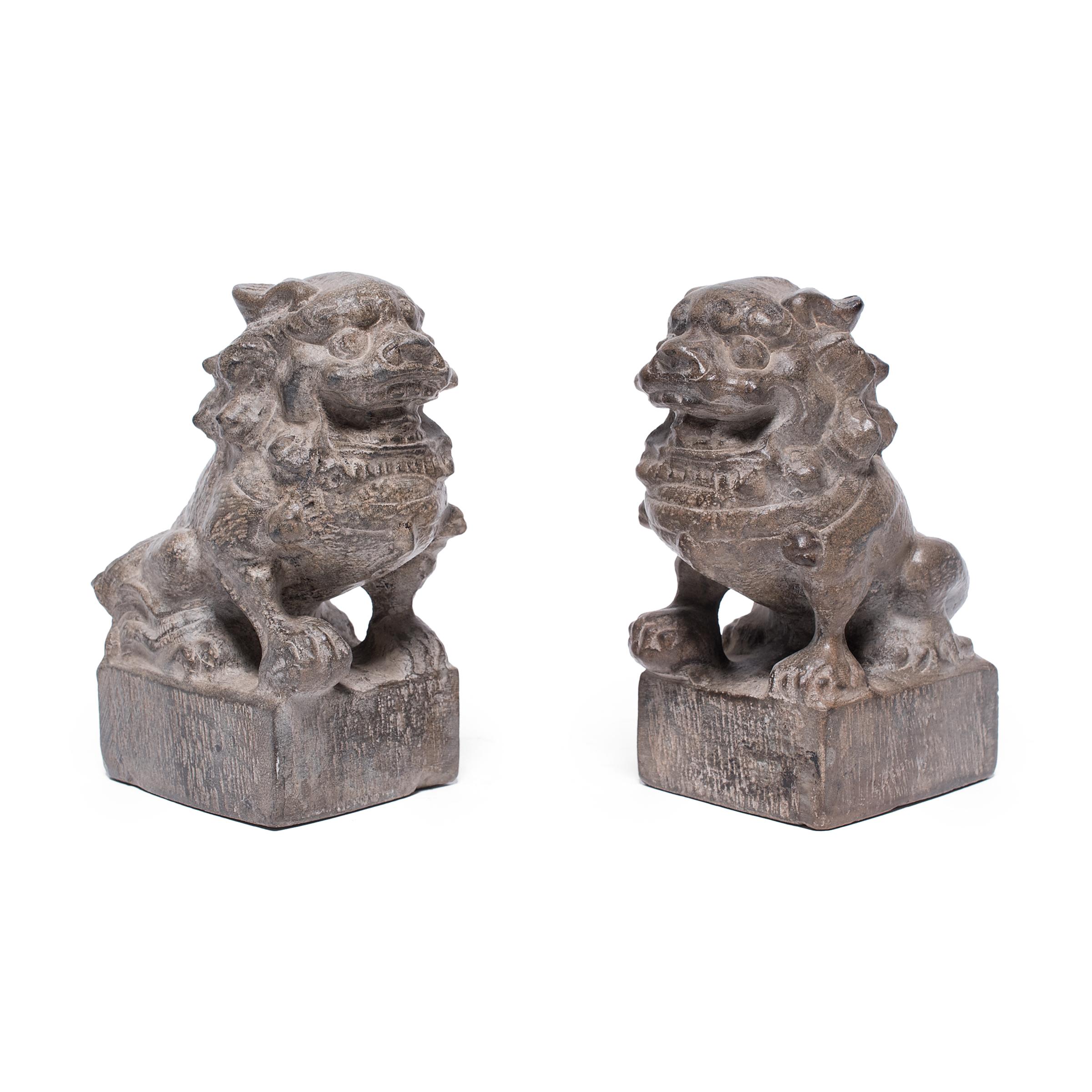 With curly manes and lively expressions, these petite stone fu dogs are adorable companions and benevolent guardians of the home. Also known as shizi, the pair represents yin and yang, the dual forces of the universe. They sit in matching postures