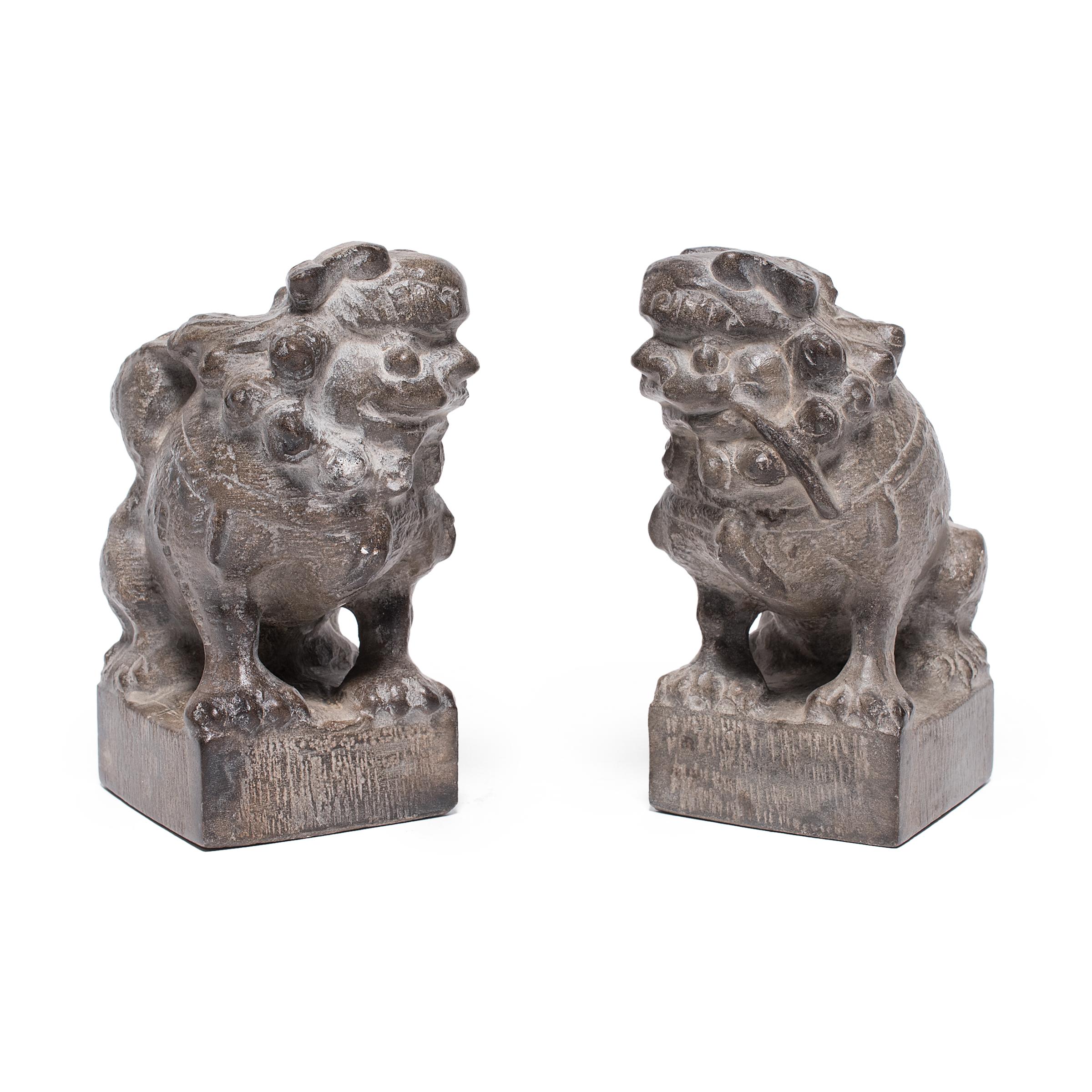With curly manes and playful expressions, these petite stone fu dogs are adorable companions and benevolent guardians of the home. Also known as shizi, the pair represents yin and yang, the dual forces of the universe. Seated in mirrored postures,