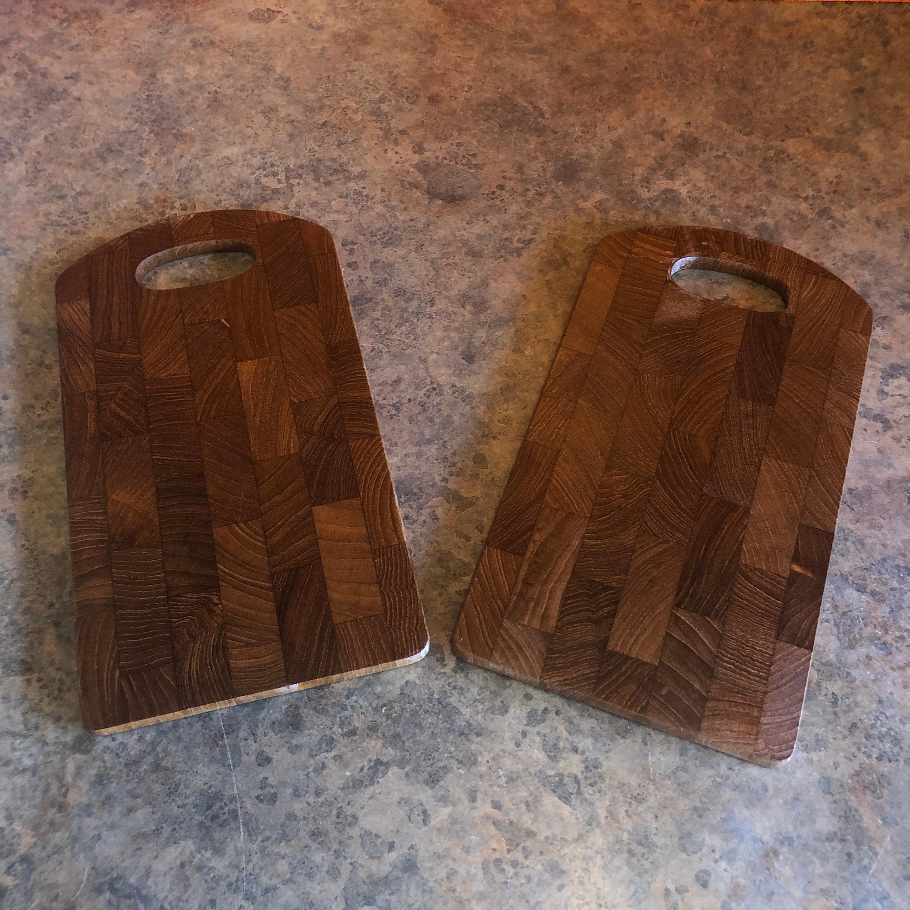 Pair of petite Danish modern teak cutting boards or trays by Jens Quistgaard for Dansk, circa 1960s. The boards are solid teak and measure 6