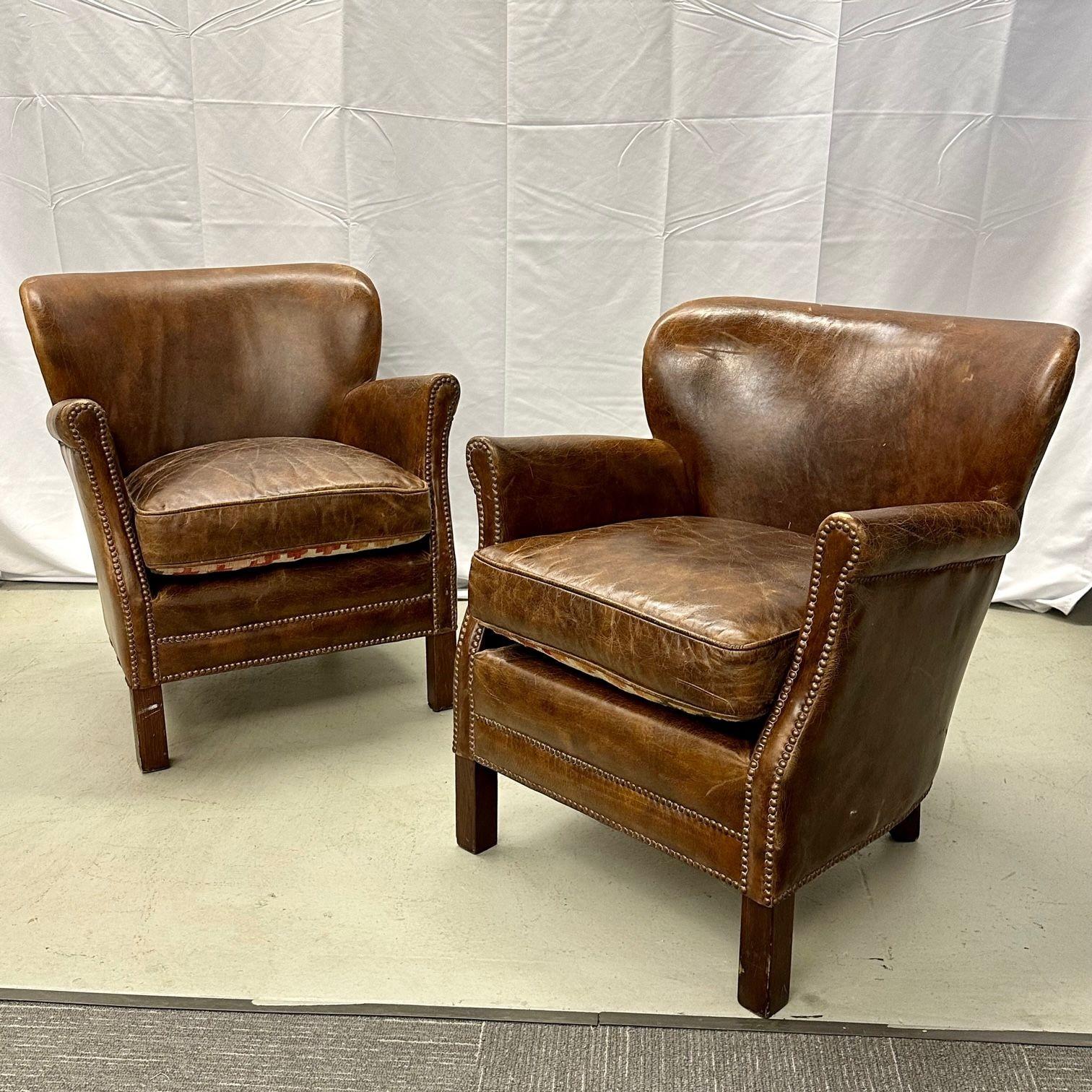 Pair of Petite Distressed Leather Club / Lounge / Arm Chairs, Danish Style
A tasteful pair of Georgian style arm or small lounge chairs bearing beautifully distressed leather. The low fan backs and rolled arms are indicative of the Georgian period.