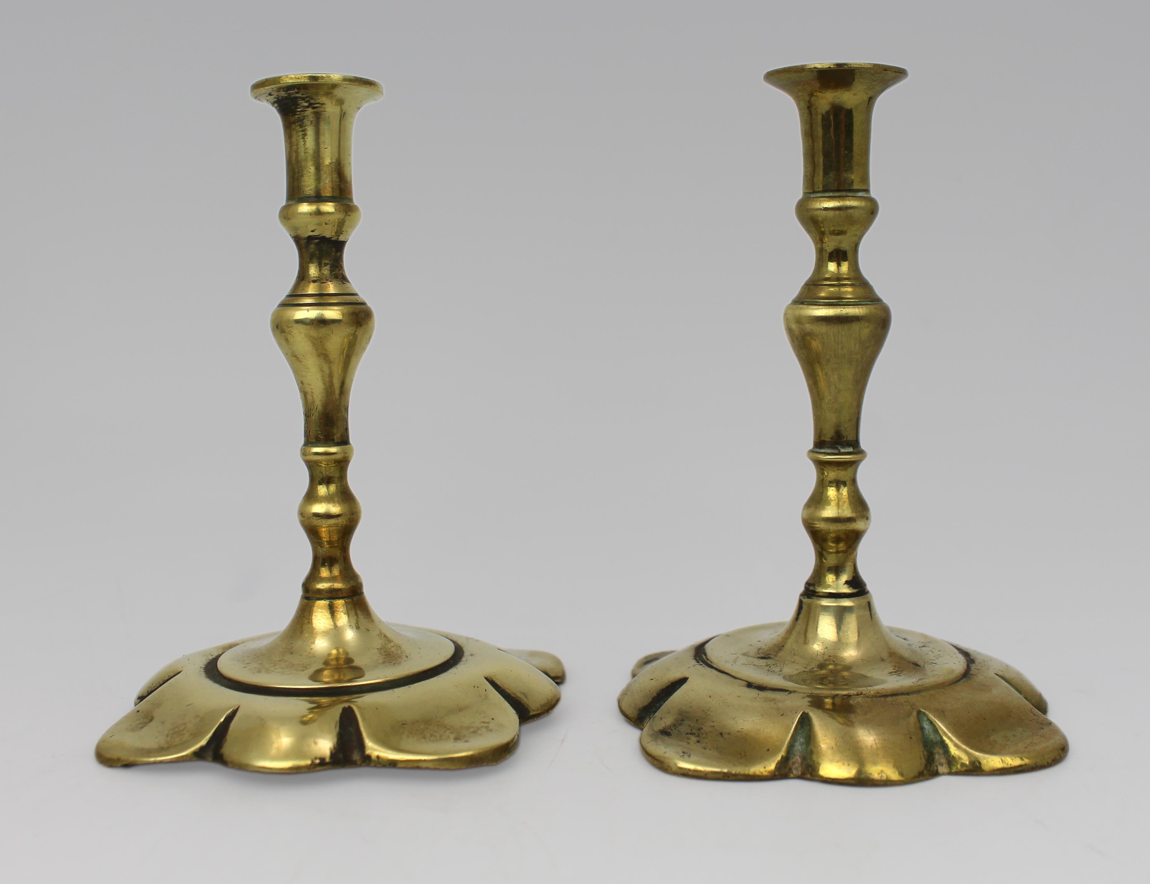 Pair of Petite English Brass Petal-Base Candlesticks, circa 1900

A finely cast pair of small-scale English brass candlesticks, dating to the turn of the 20th century. Each with an elegant knopped stem rising from a shaped petal-form base, designed