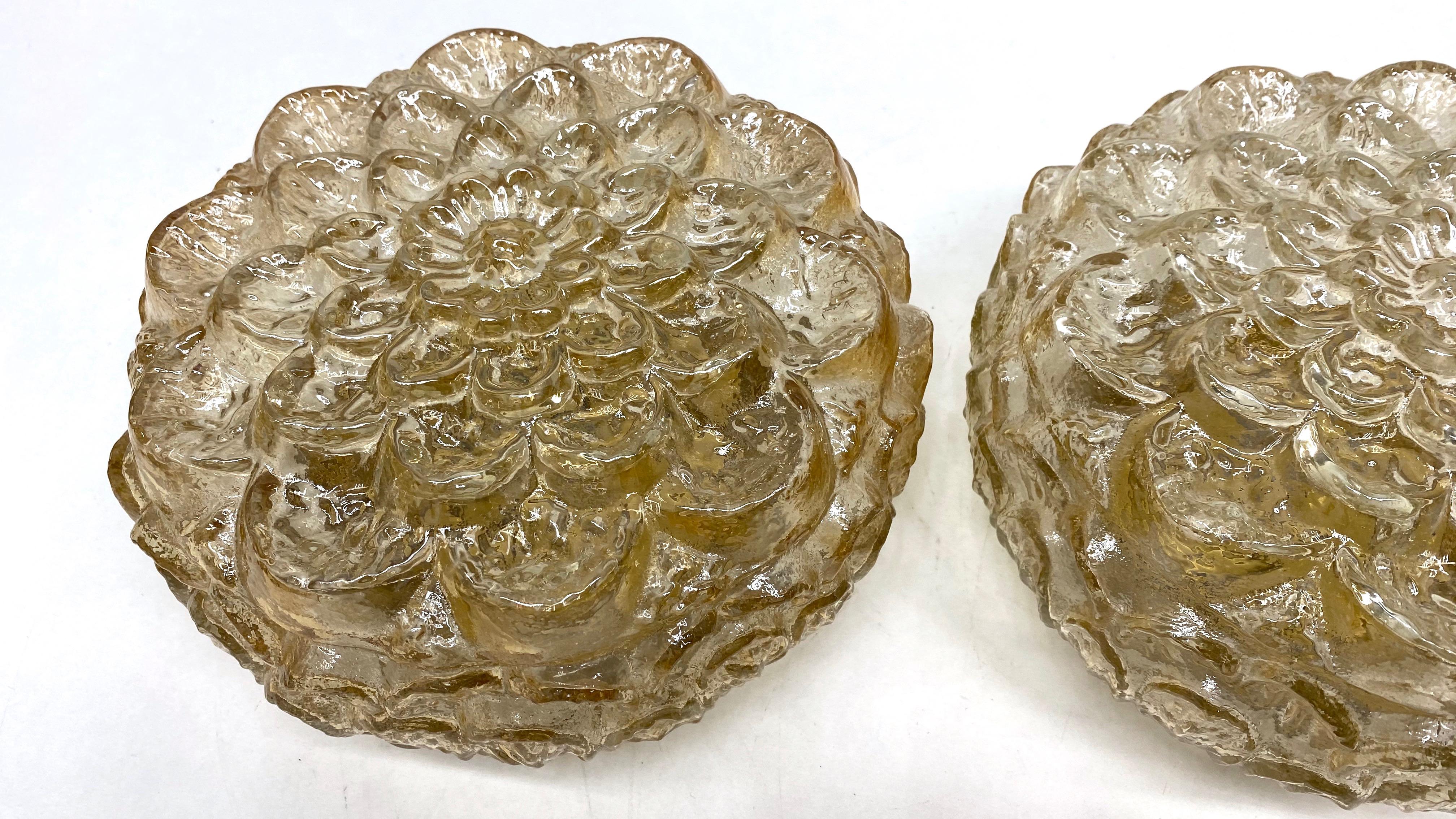 Petite pair of flower pattern amber glass flush mount. Made in Germany by RZB Leuchten. Gorgeous textured glass flush mount with metal fixture. Each fixture requires one European E14 candelabra bulb up to 40 watts.