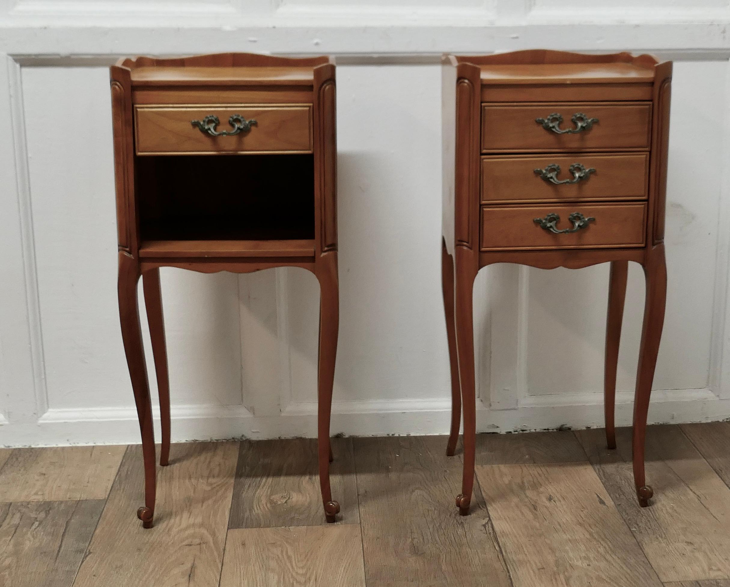 Pair of Petite French Cherry Wood Bedside Cabinets or Tables

This is a pretty pair of cabinets or chevets, they stand on shaped cabriole legs and a small gallery around the top, one has 3 drawer to the front  and the other has one drawers and an