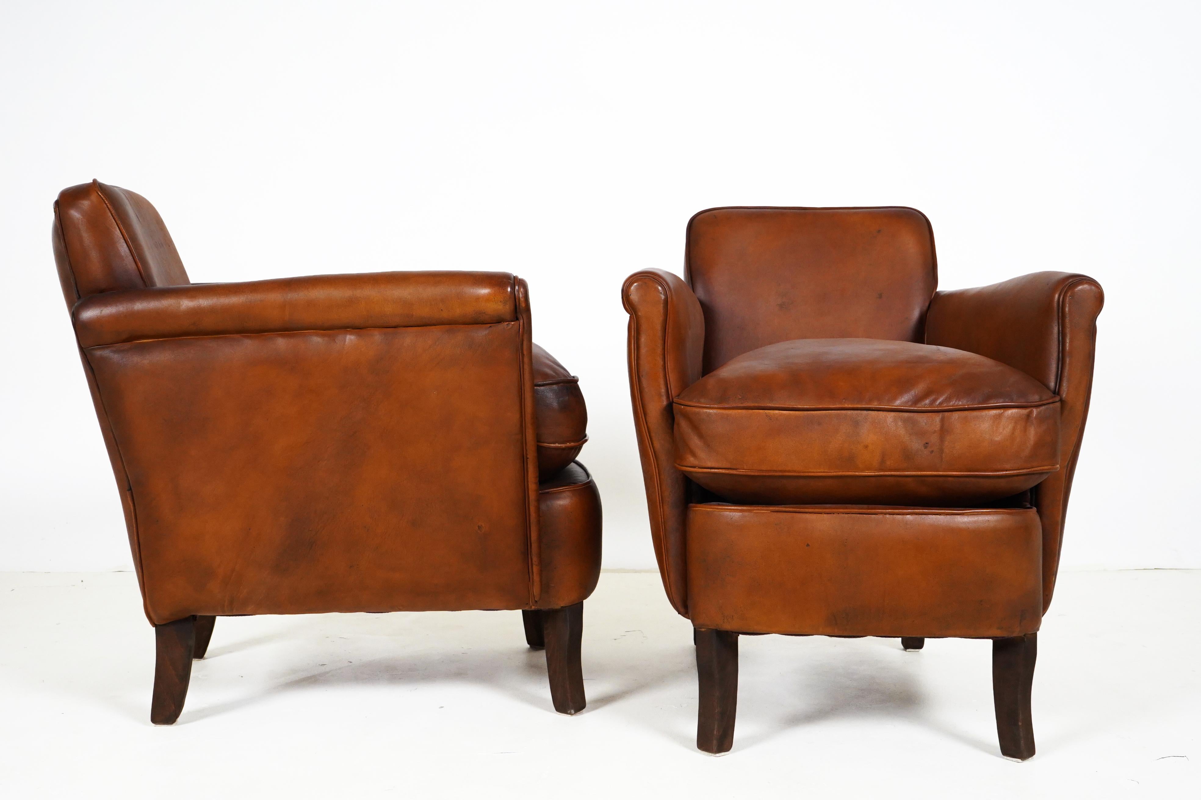 These compact leather chairs feature bold, sheep leather, thick padded seats and slim, roll panel arms.