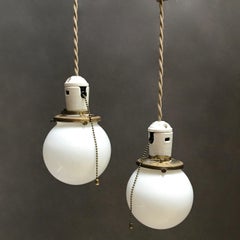 Pair of Petite Industrial Milk Glass and Porcelain Globe Pendant Lights