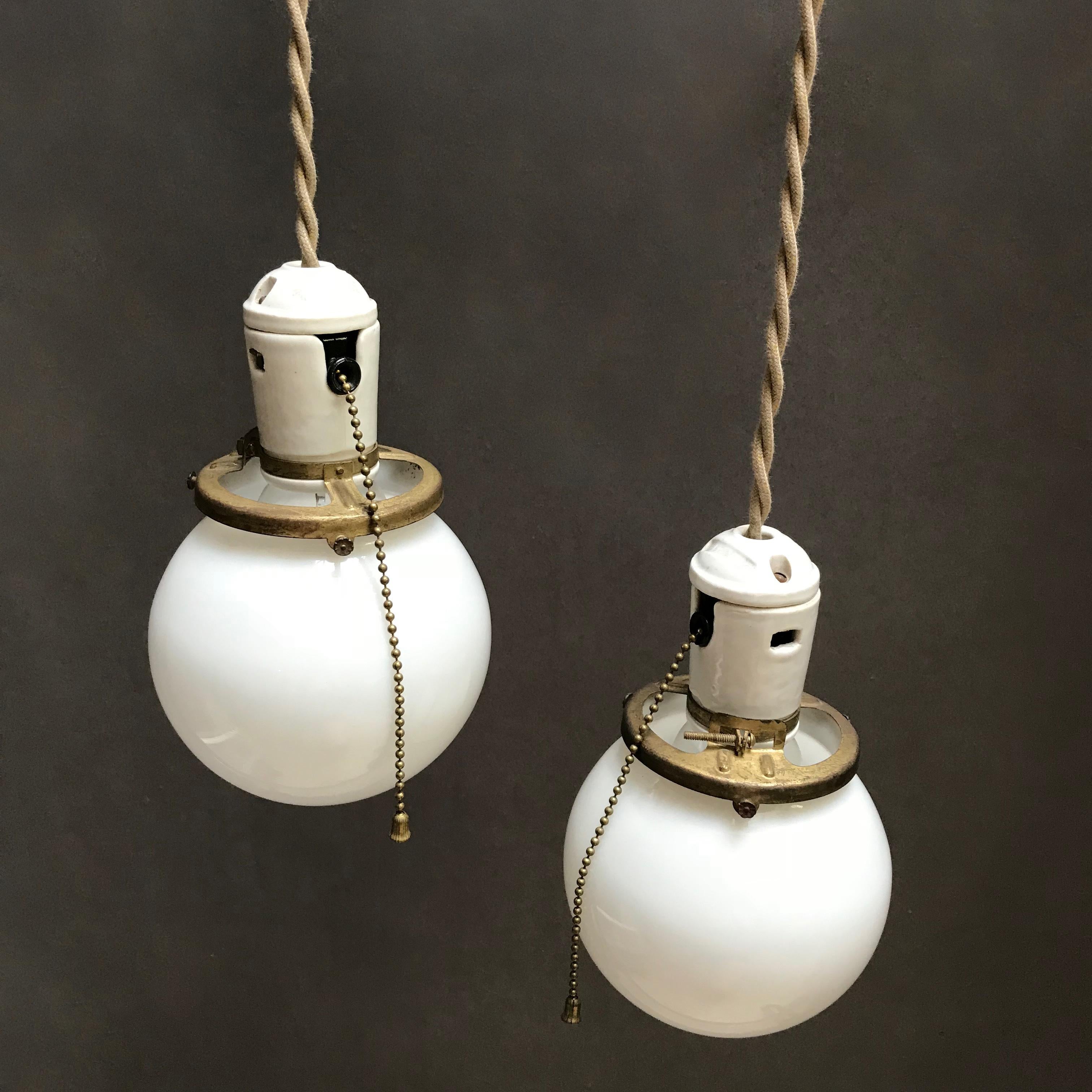 American Pair of Petite Industrial Milk Glass and Porcelain Globe Pendant Lights