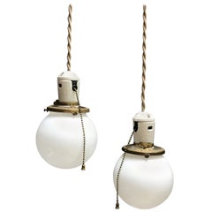 Pair of Petite Industrial Milk Glass and Porcelain Globe Pendant Lights