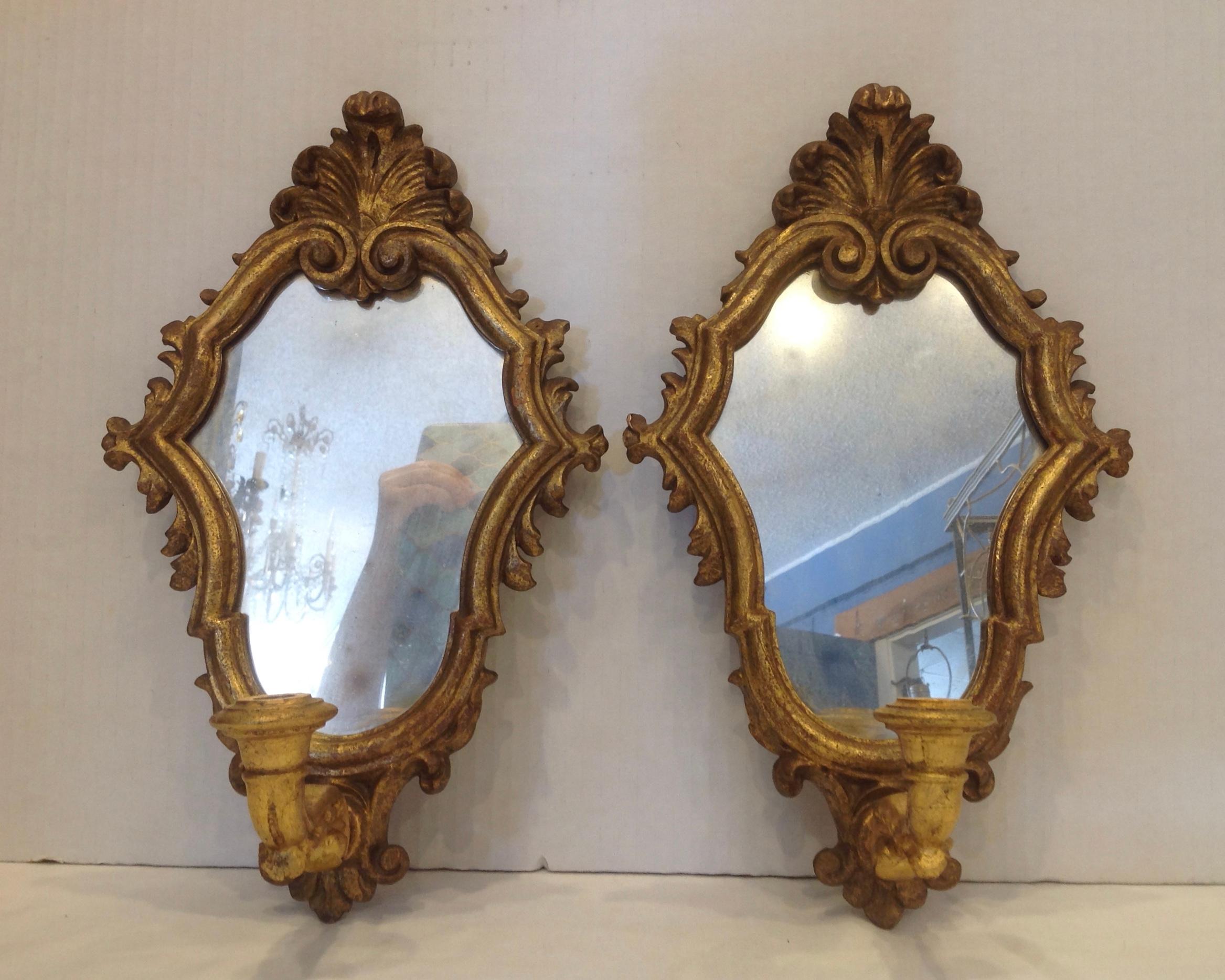 Lovely carved giltwood accent sconces fashioned with plume like crests.