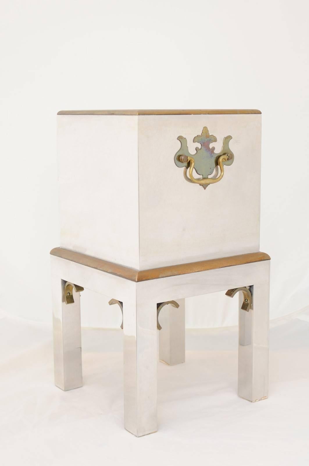 A pair of Italian petite vintage steel and brass boxes on stands from the second half of the 20th century, with Chippendale style hardware. Each of this pair of Italian boxes on stands features an exquisite lustrous steel body, accented with