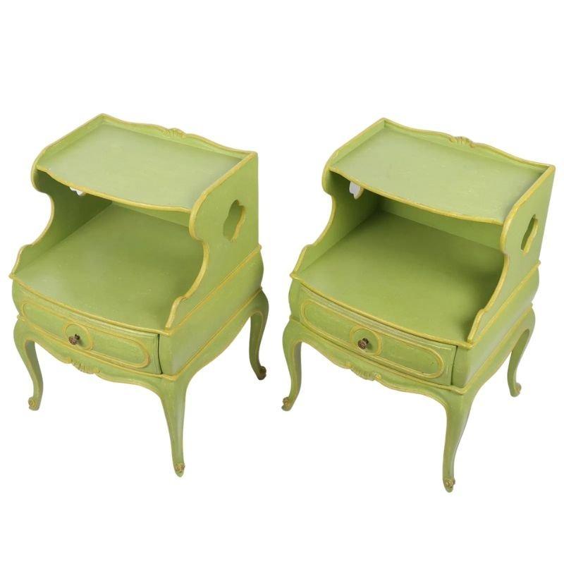 A pair of French style night stands painted a bright lime green with yellow accents. The night stands feature a shaped design with carved details, a drawer highlighted with raised yellow molding surrounding the small round drawer pull, an open shelf