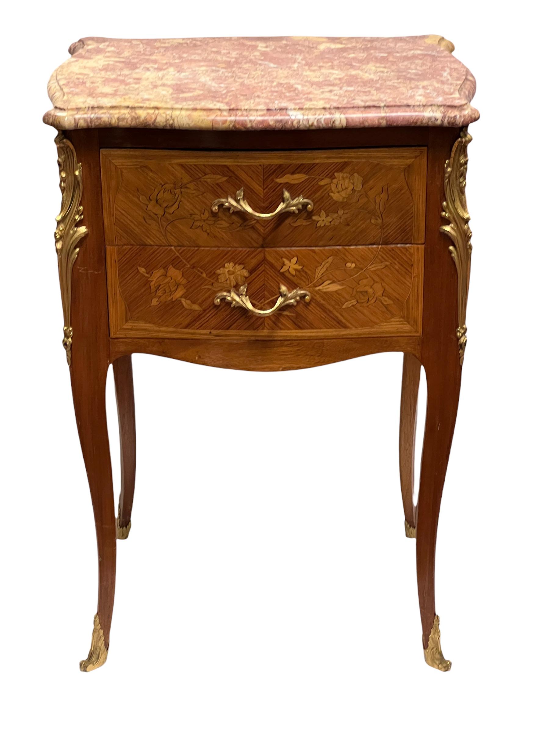 Pair of Louis XV Style French 19 century Marquetry inlaid gilt bronze mounted marble top two drawer end tables.
 