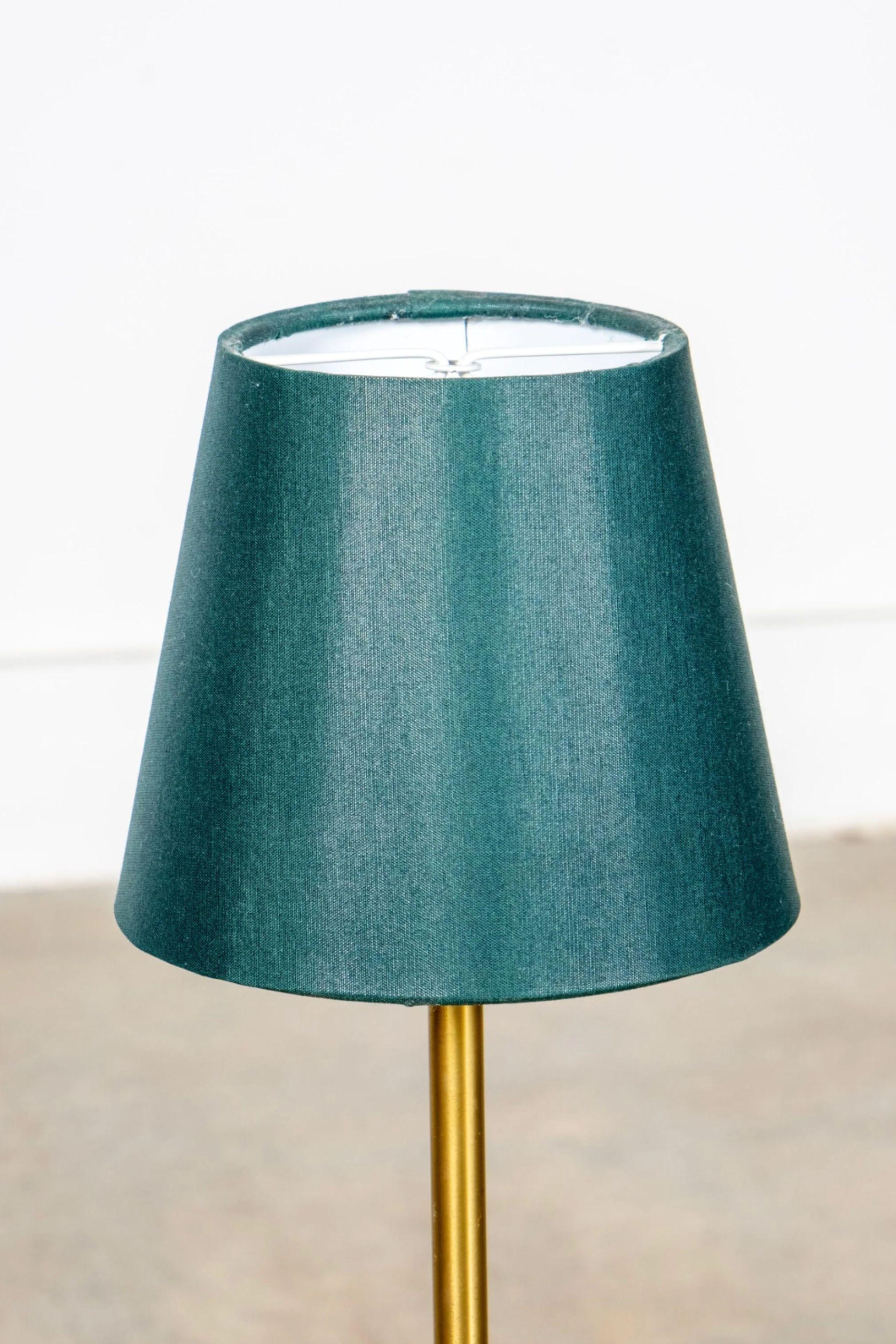 Pair of mid-century brass table lamps by Swedish sculptor and designer Sonja Katzin (1919 – 2014). Produced by ASEA, the lamps have a slender stem anchored by a substantial conical base. A cast relief pattern provides linear intrigue, drawing your