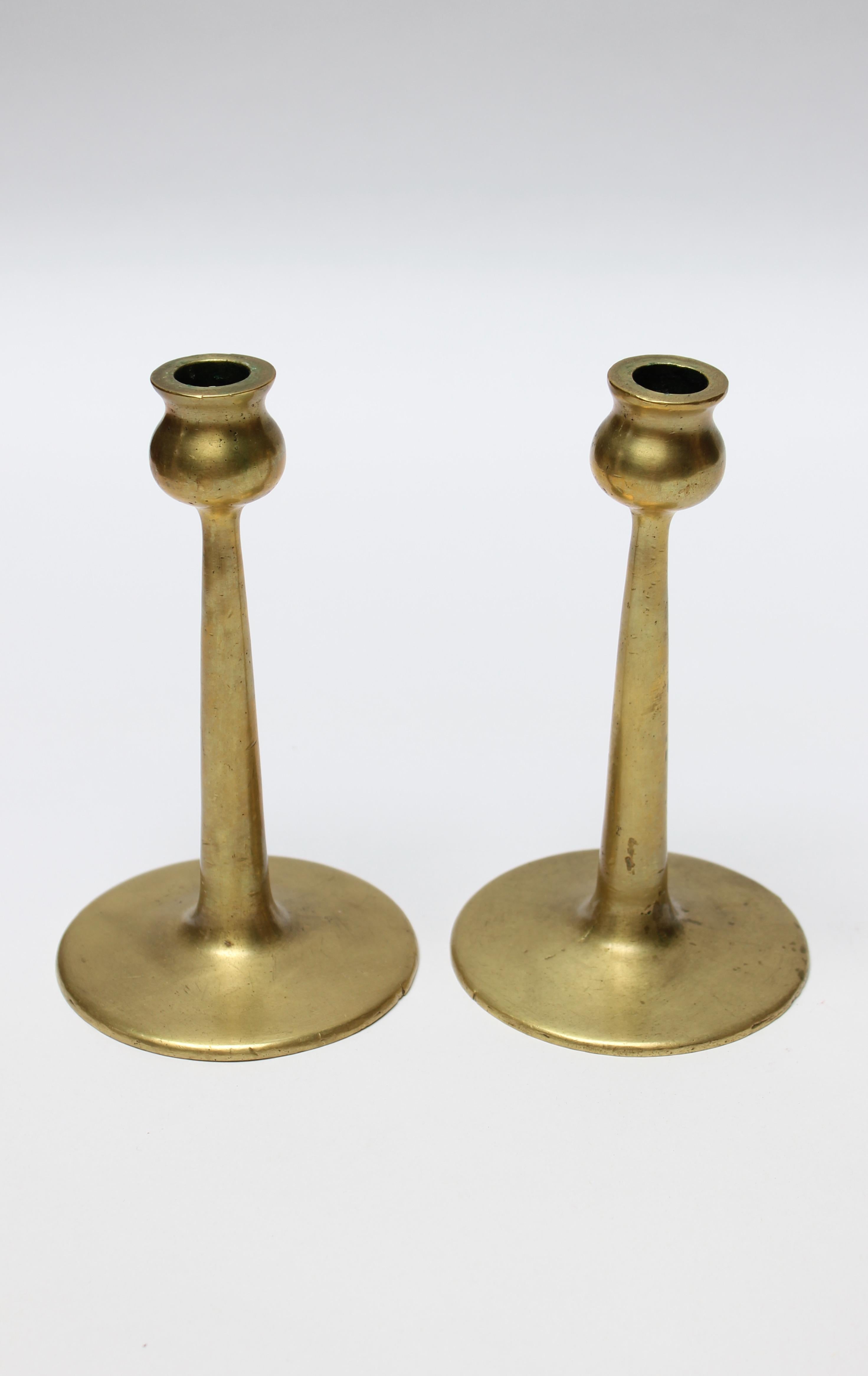 Mid-century brass turned candlesticks, each with bulbous bobeche and cylindrical stem on circular, disk base.
Beautifully aged, showing natural patina (unpolished). 
Measures: Height 6.75