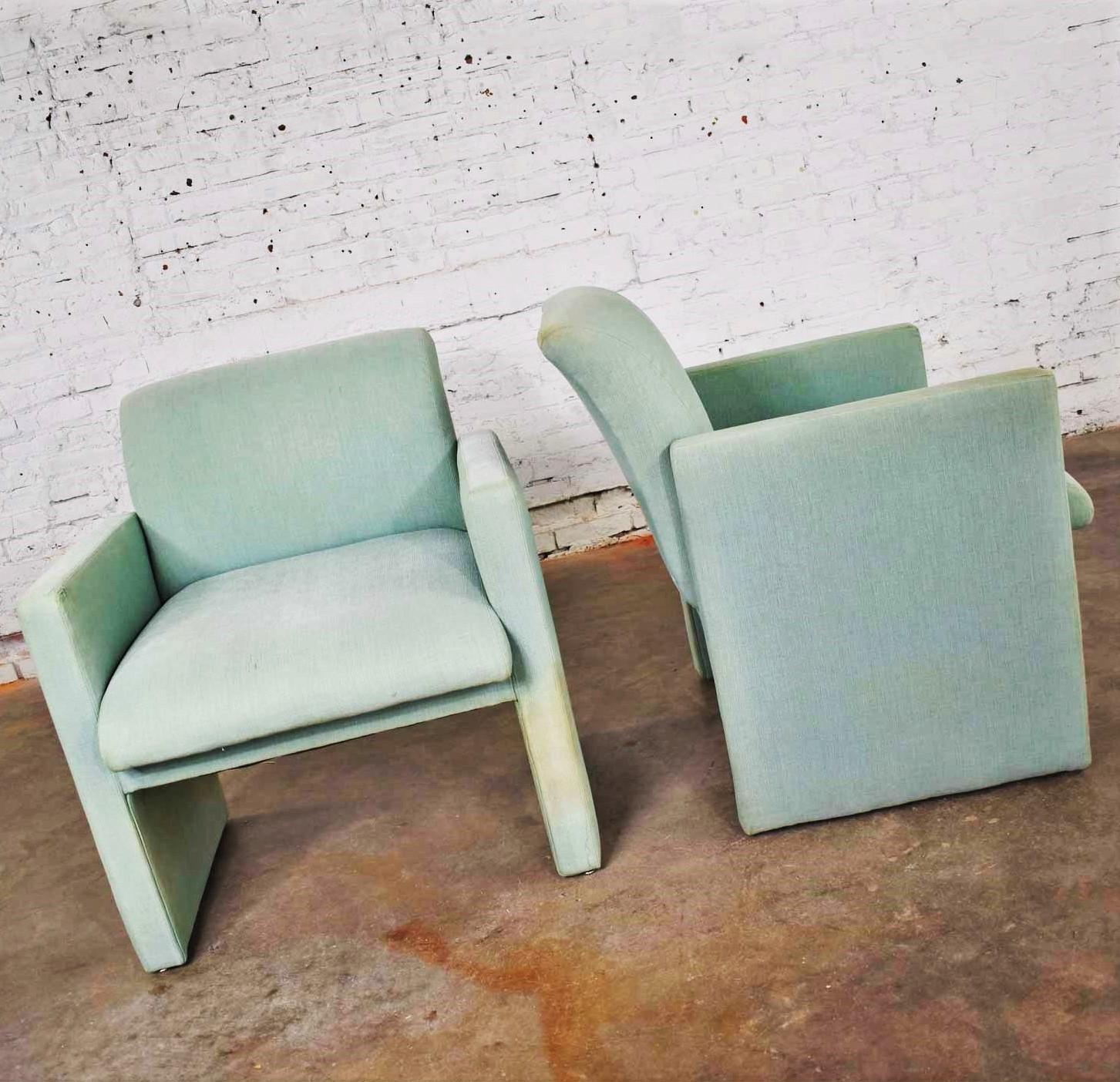 Handsome petite pair of modern accent chairs. They are currently in a sea green upholstery, but it is showing lots of wear, fading, and stains. We are sure you will want to recover. However, we still gave them a good shampoo. Otherwise they are in