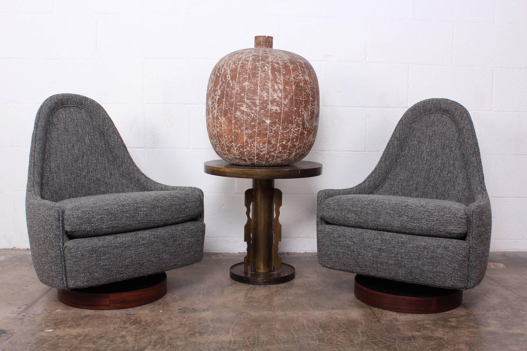 A small-scale pair of rocking swivel chairs on rosewood bases. Designed by Milo Baughman for Thayer Coggin. Fully restored.
  