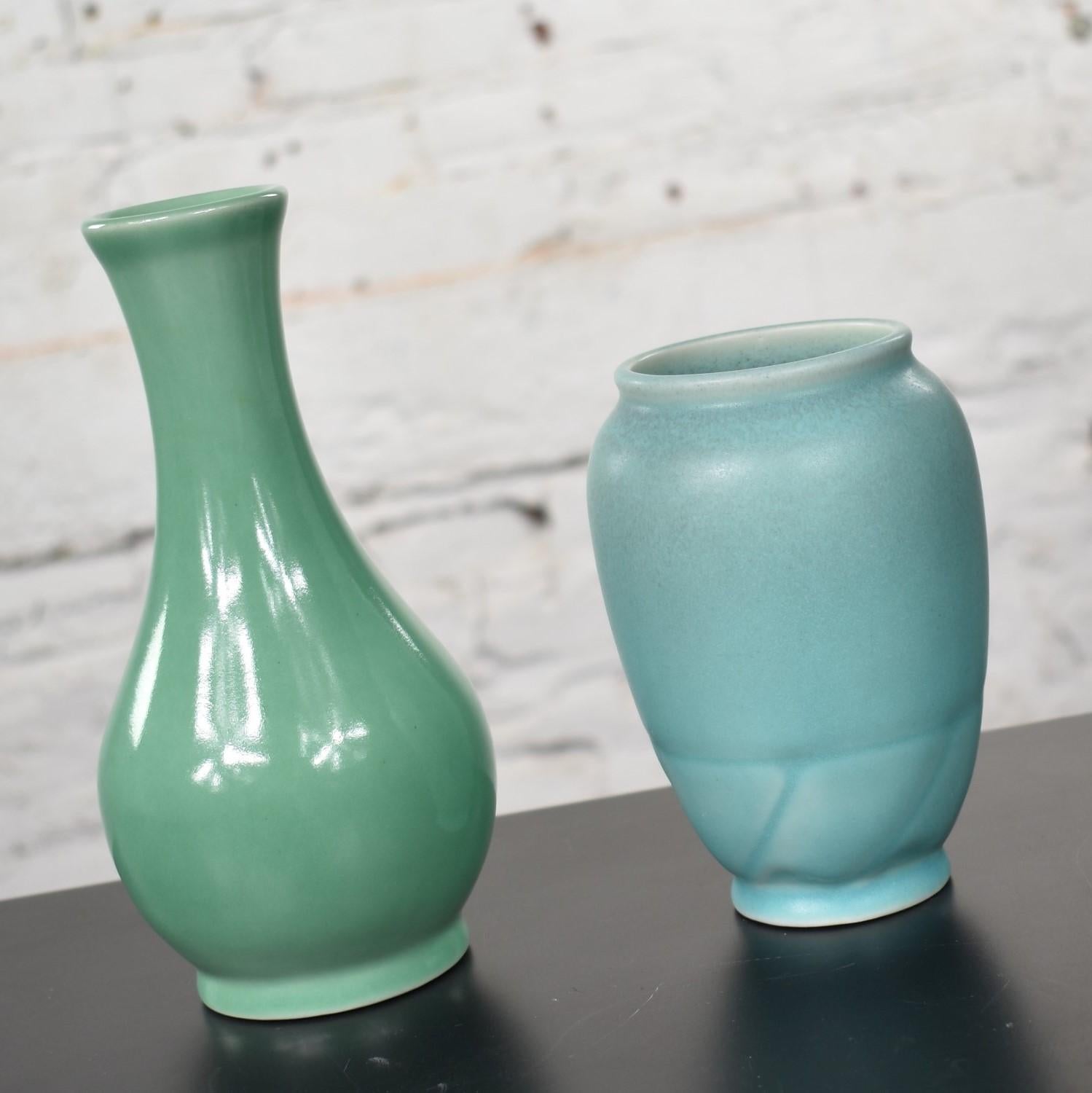Handsome pair of petite Rookwood Pottery Arts & Craft vases. One is sea green and one is turquoise. They are both in excellent vintage condition. No chips, cracks, chiggers, or crazing that we have detected and very little wear to their bottoms.