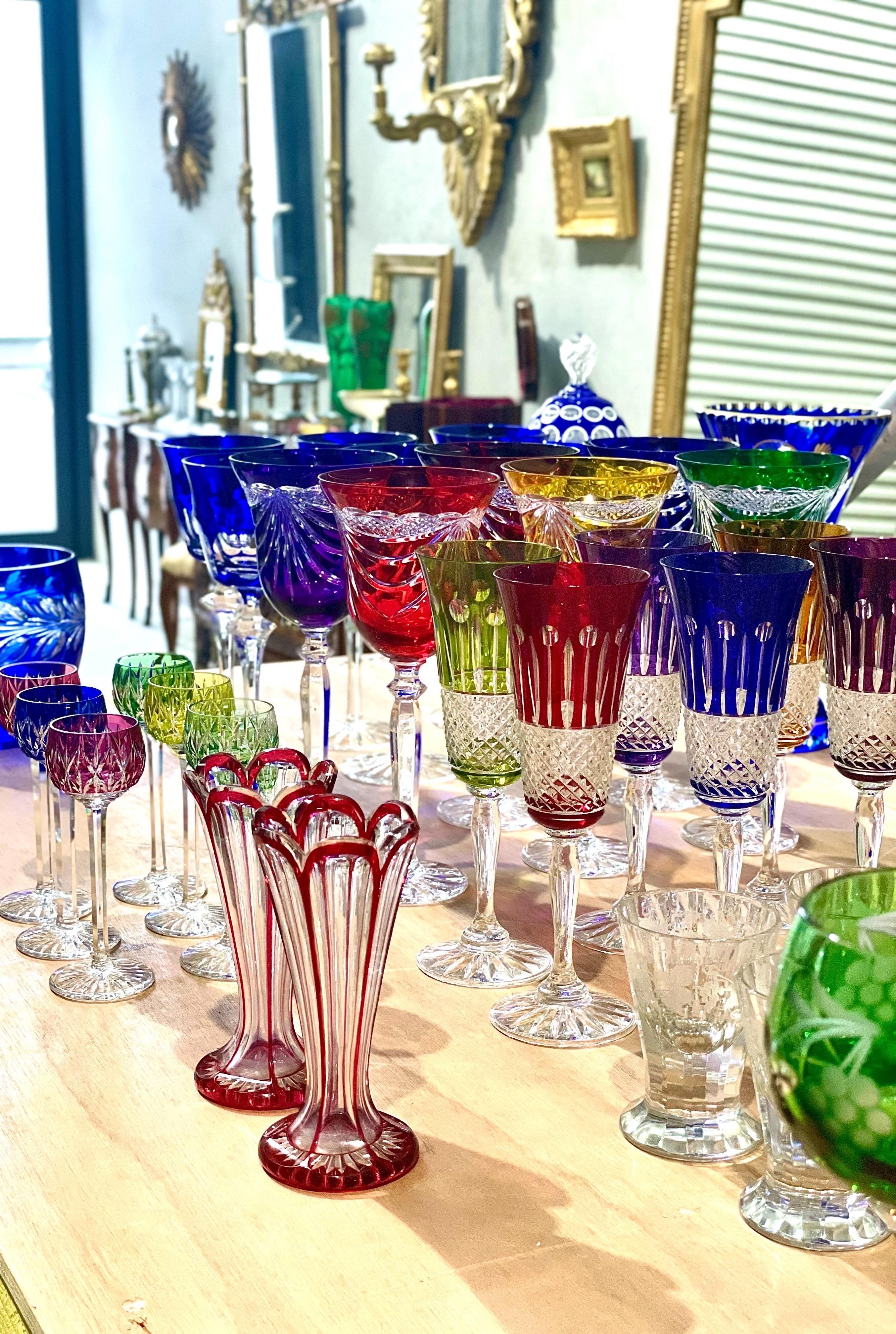 This exquisite pair of ruby red overlay crystal vases, attributed to Saint Louis,  showcases the refined artistry and precision of 19th-century glassmaking. Each vase features a fluted body with elegantly scalloped rims and deep ruby overlay,