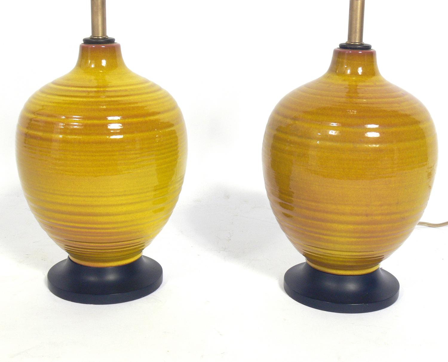 Pair of Petite yellow ceramic lamps, probably Chinese, circa 1970s. Vibrant yellow color. The price noted below includes the shades. Rewired and ready to use.