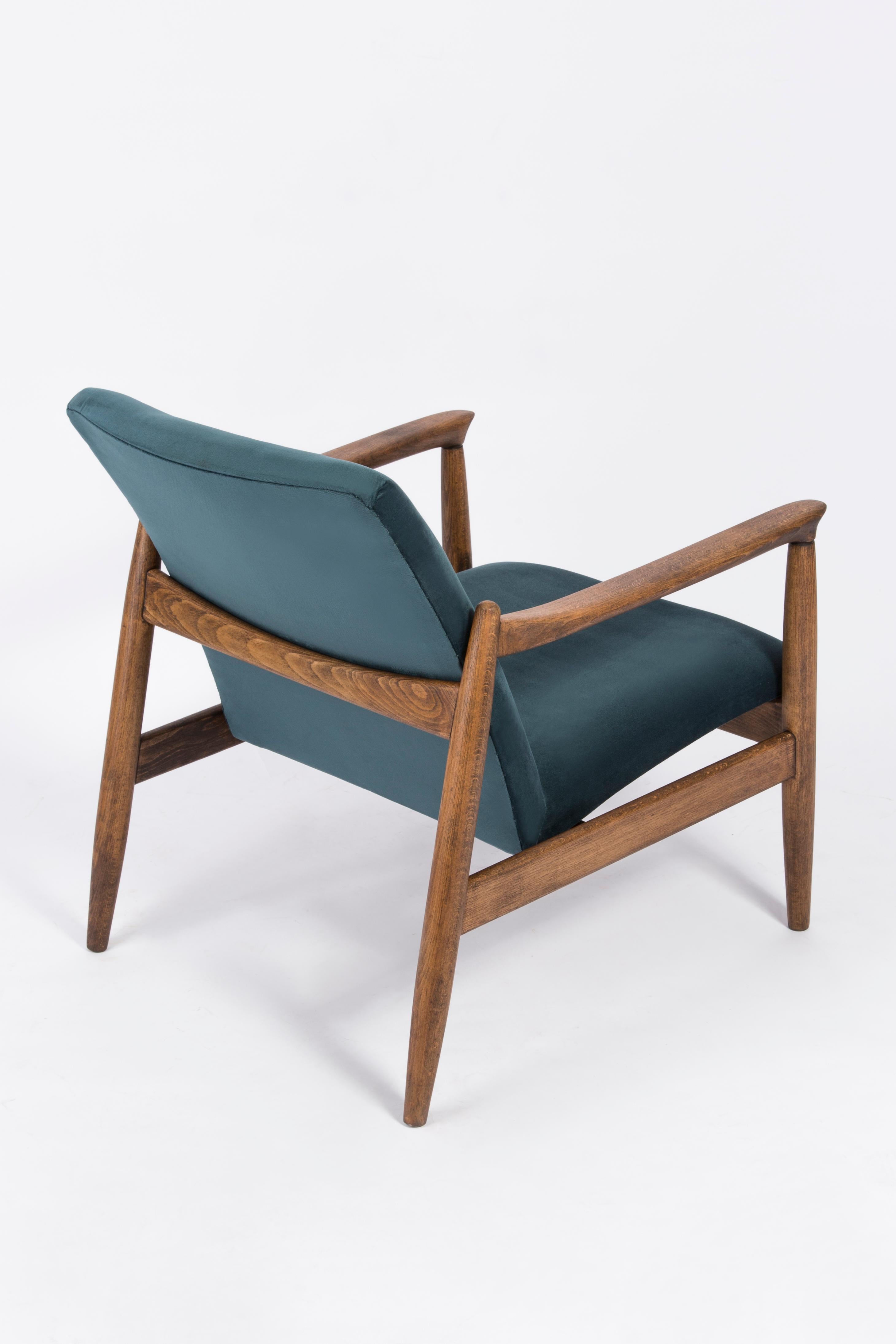 Petrol blue armchair, designed by Edmund Homa. The armchair was made in the 1960s in the Gosciecinska Furniture Factory from solid beechwood. The GFM type armchair is regarded one of the best Polish armchair design from the previous age. The