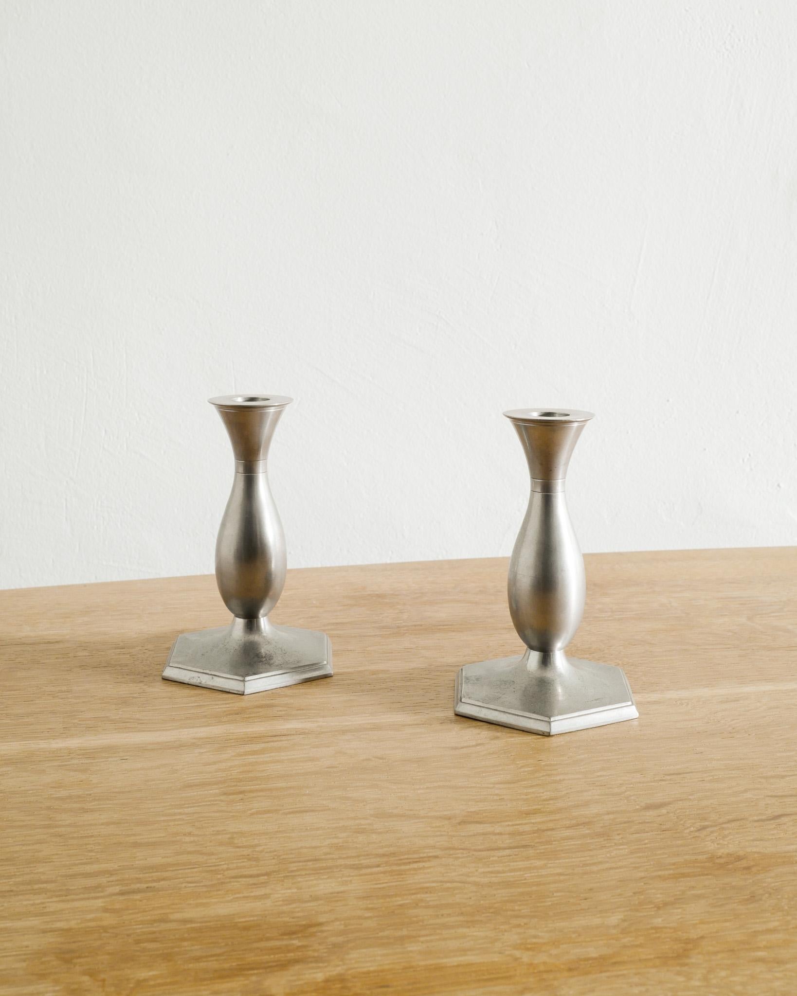 Rare pair of Danish mid century pewter candlesticks holders produced in Denmark, 1940s. In good original condition. Stamped. 

Dimensions: H: 16 cm / 6.30
