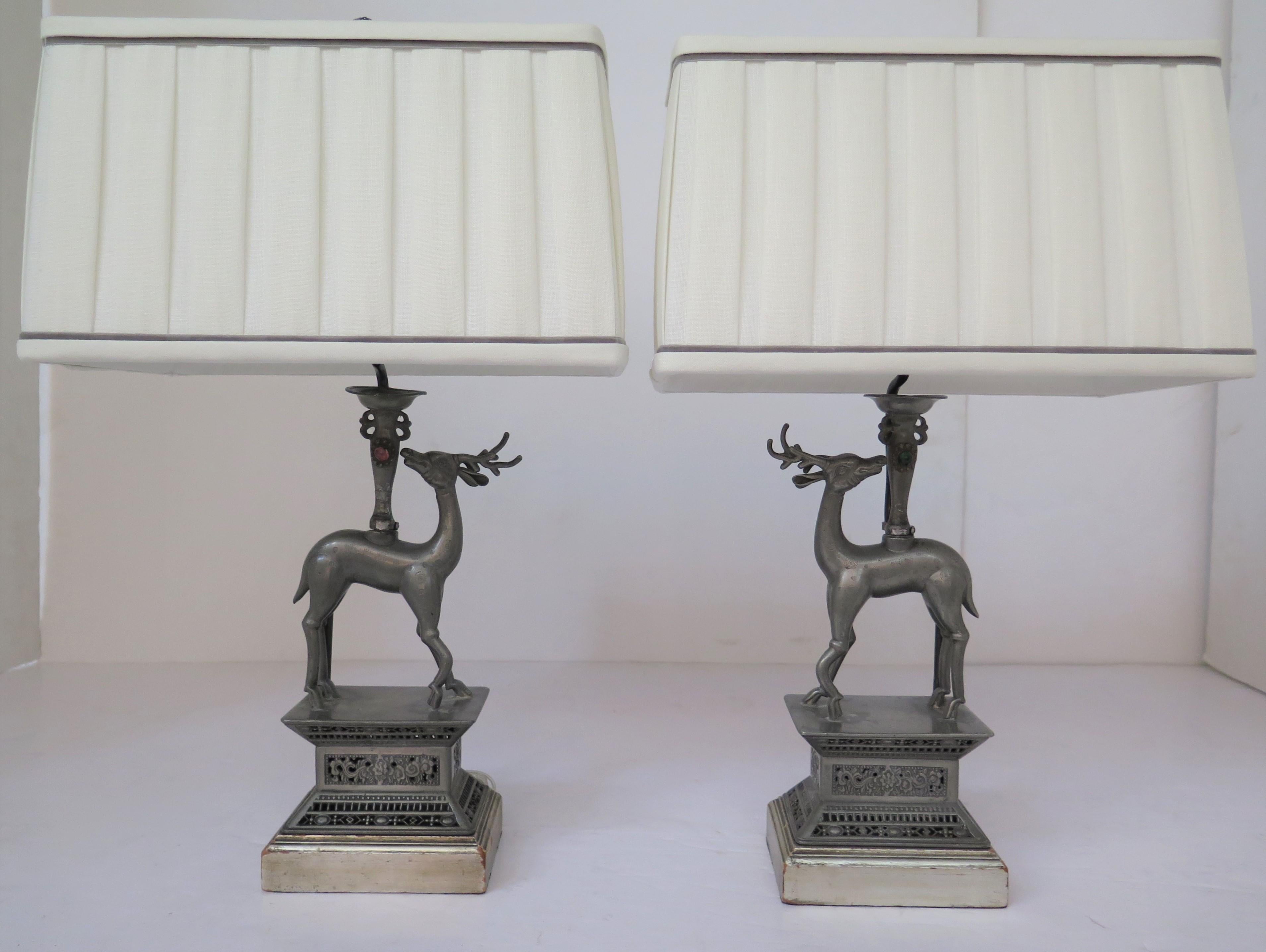 a handsome pair of pewter Chinese Art Deco deer table lamps on silver gilt wooden bases with custom pleated rectangular box shades, China, circa 1920s

22'' H x 14.5'' W x 9.5'' D

6'' x 4.5'' base 