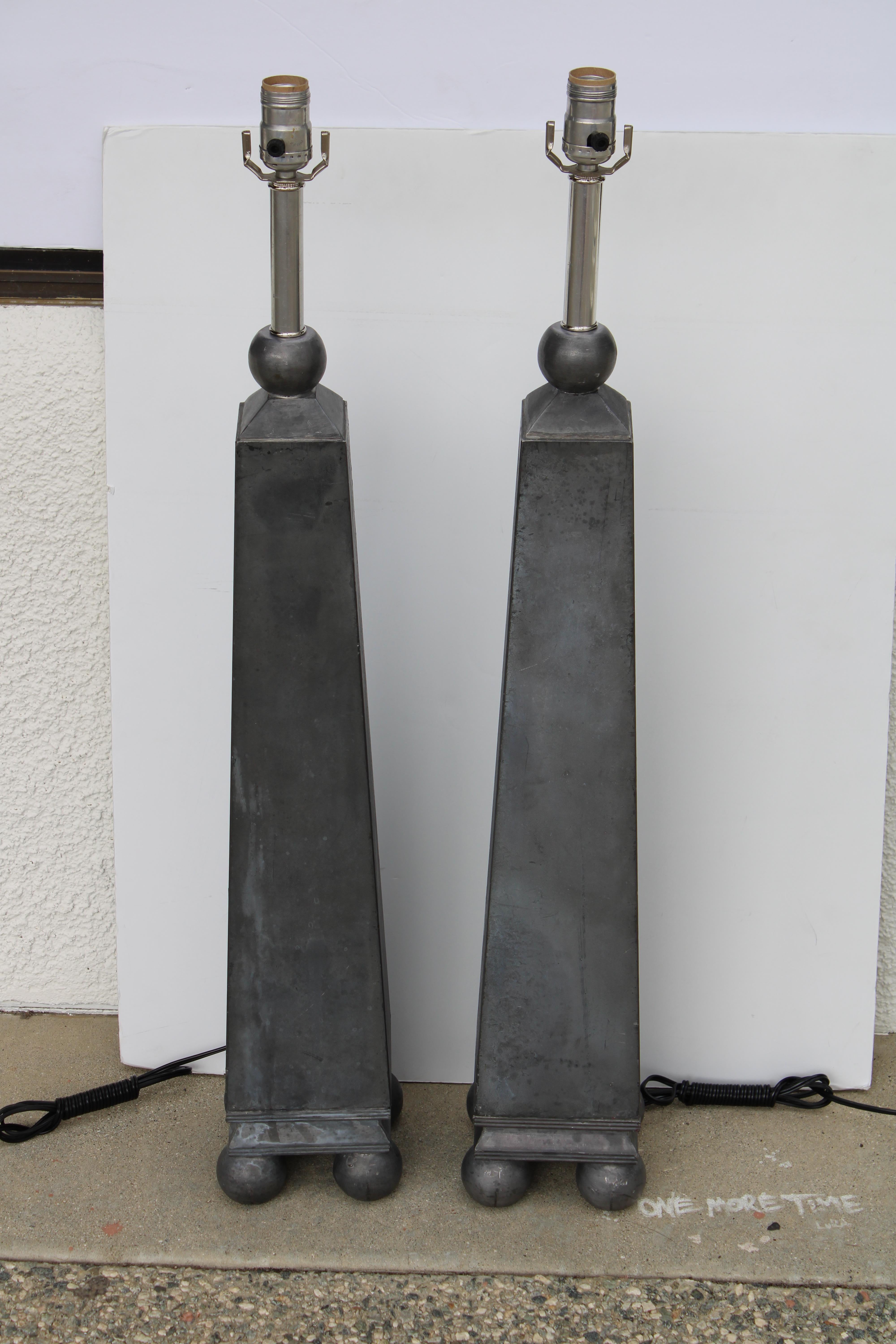Heavy solid pewter table lamps, obelisk forms with spherical feet.  Lamps have been professionally rewired for 3-way light bulbs  Lamps measure 5.5