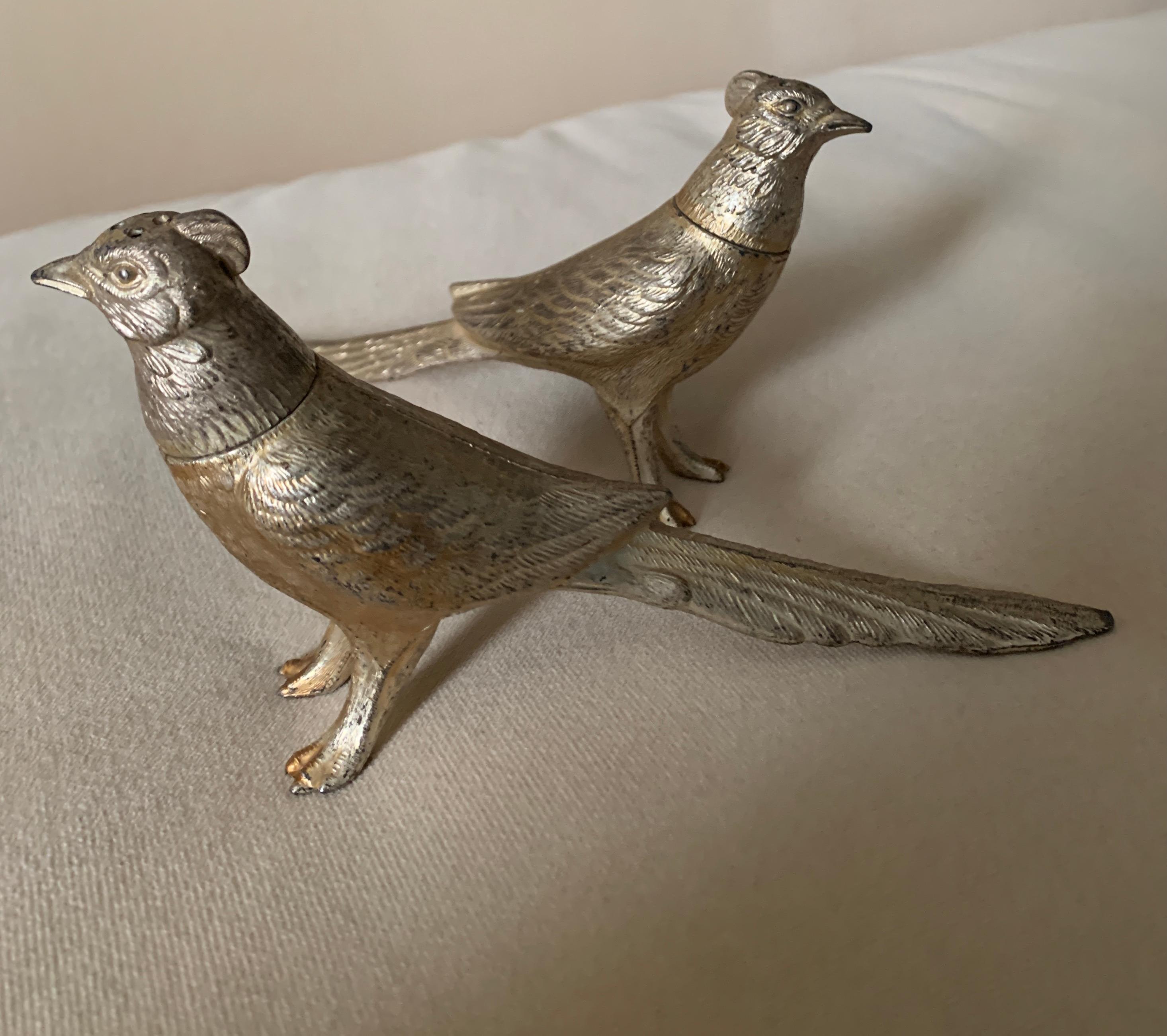 A pair of Pheasant salt and pepper shakers. The pair are a wonderful addition to any table and especially those on Thanksgiving or the holidays. The pair have a nice patination and look to be white gold leafed. Easily opened by unscrewing the heads.