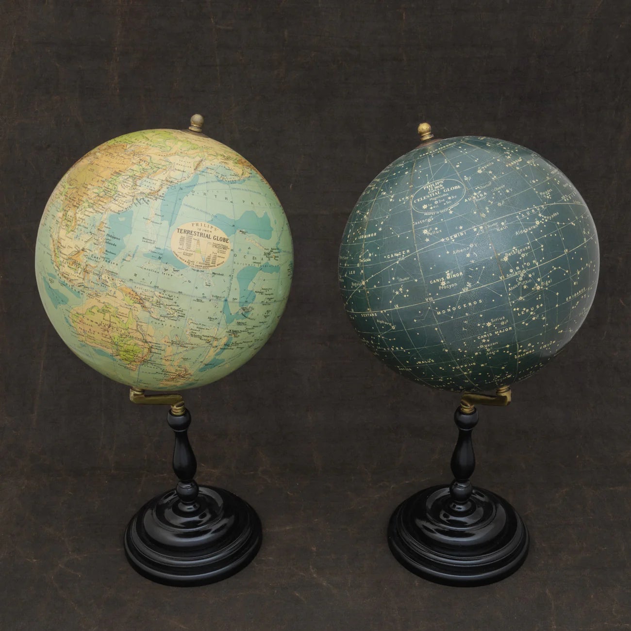 A wonderful set of Terrestrial and Celestial 12 inch globes by George Philip and Son. Presented on brass inclined plain mounts attached to original turned ebonized wooden bases and uprights with axes secured at the top by brass acorn finials.