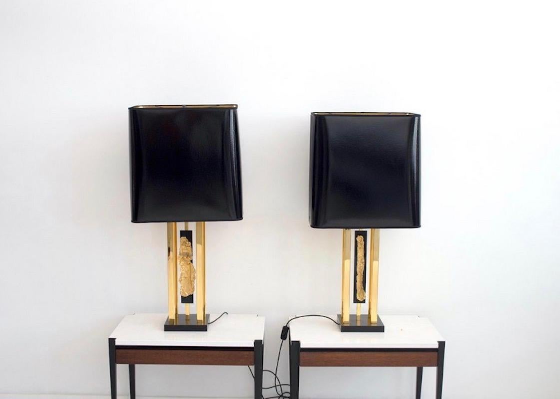 Pair of large table lamps by French artist and designer Philippe Cheverny from circa 1970. Black laminated wood base, brass framework and golden metal decoration on black Perspex. Sleek black and golden shades have been replaced, but the size is