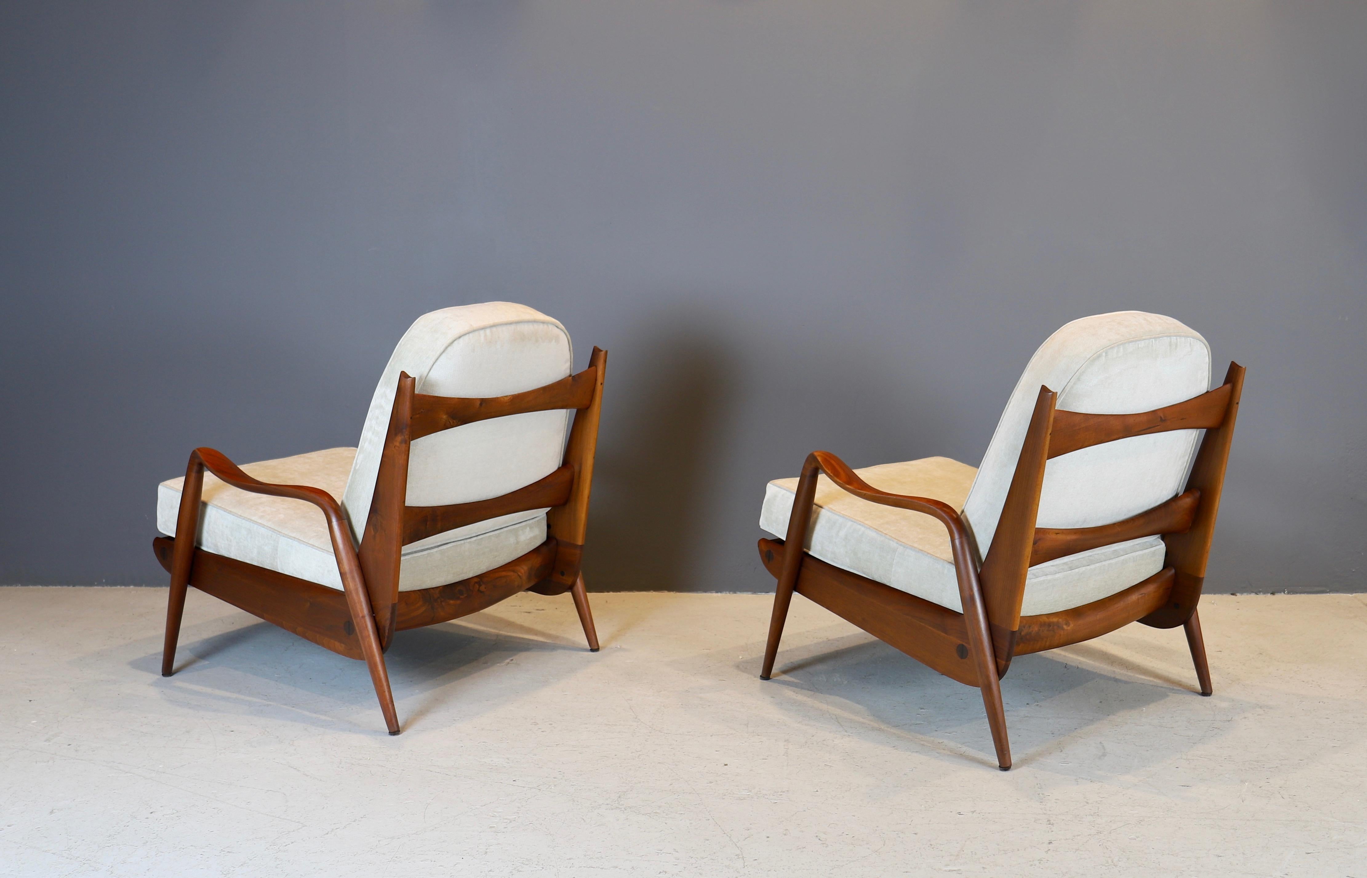 Rare pair of hand-sculpted walnut lounge chairs by New Hope studio artist Phillip Lloyd Powell, circa 1970s.
Walnut frames have been cleaned and conditioned with oil, cushions are new in Holly Hunt fabric.
  