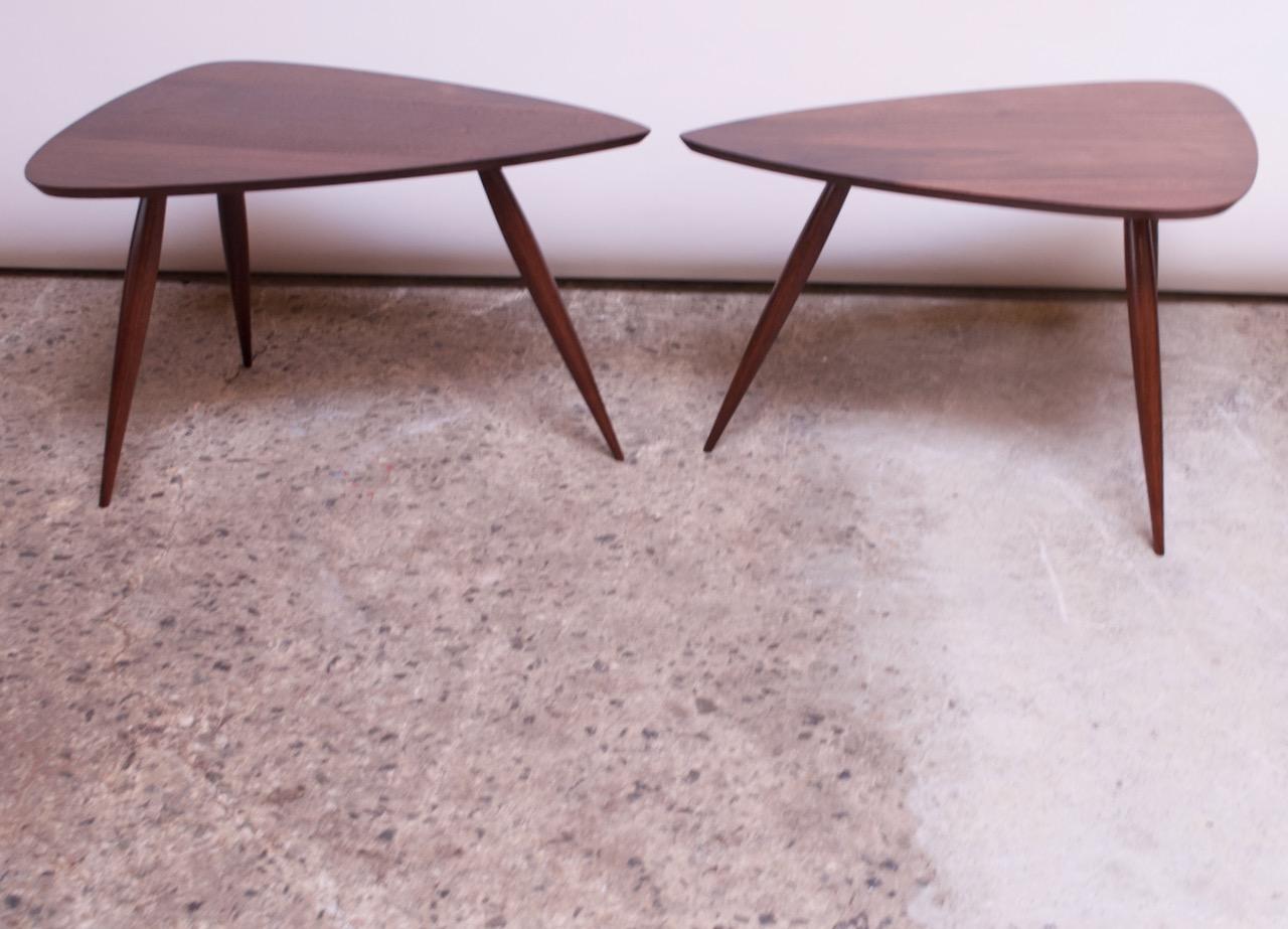 Triangular 'guitar pick' side or occasional tables crafted by Phillip Lloyd Powell in the early 1960s (New Hope, PA). 
Outstanding form with three tapered legs and sculptural top. Rich American black walnut color and vivid grain.
Very fine,