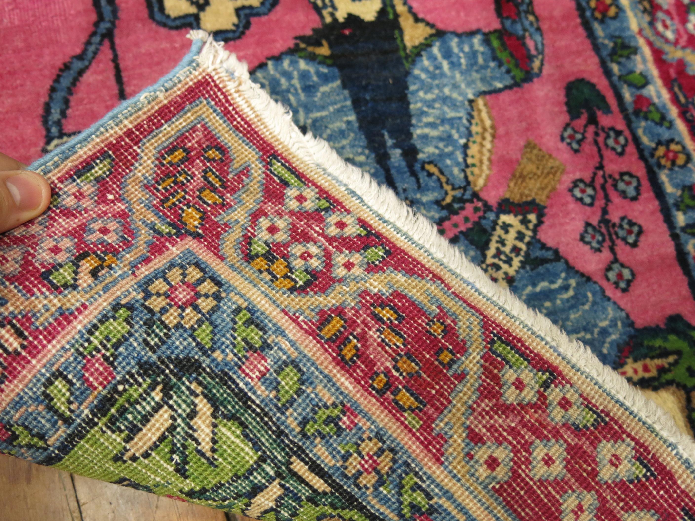 A pair of vintage Persian Kerman pictorial rugs depicting a Persian depicting a bow and arrow similar to a modern day robin hood each measuring 19'' x 24''.
