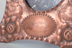 Pair of picture frames in embossed copper. Dated 1933