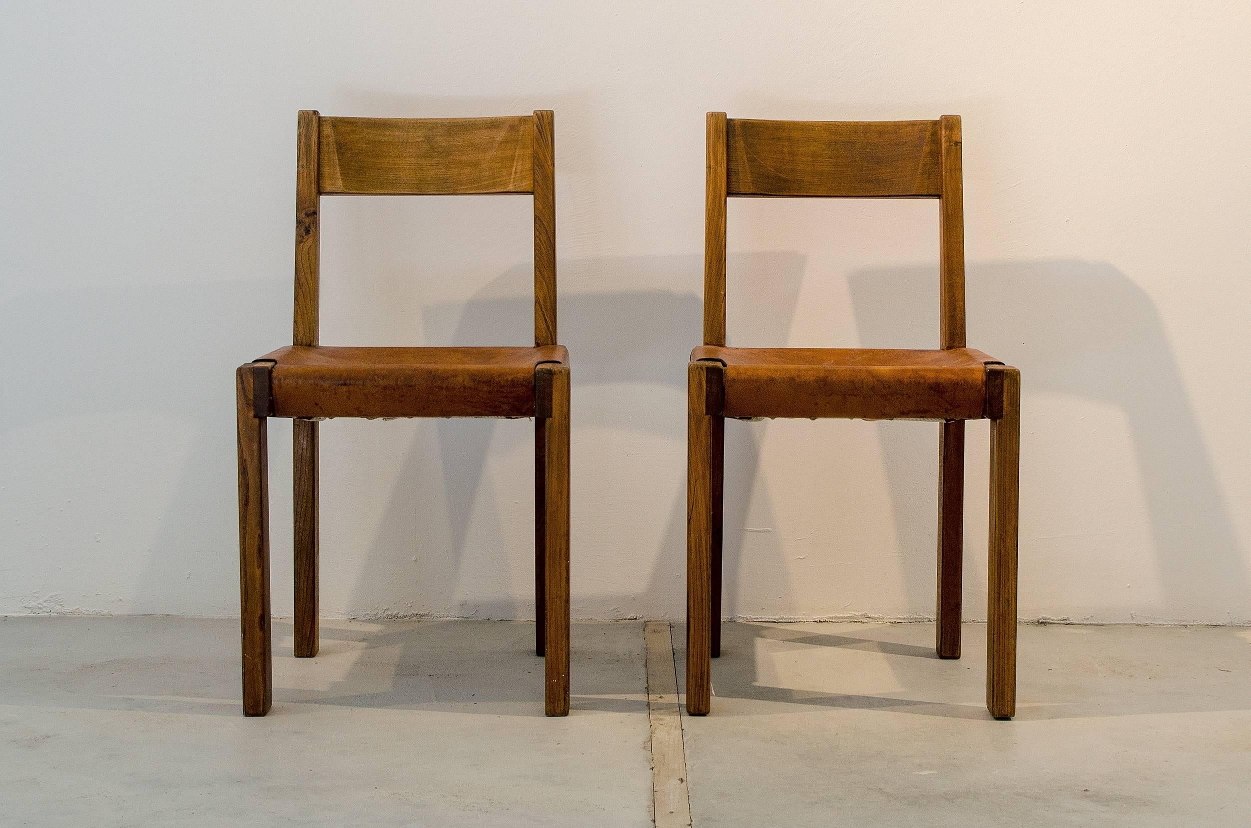 Set of two chairs designed by Pierre Chapo. 
Made of solid elm and leather. 
Place of origin: France
Date of manufacture circa 1960.
 