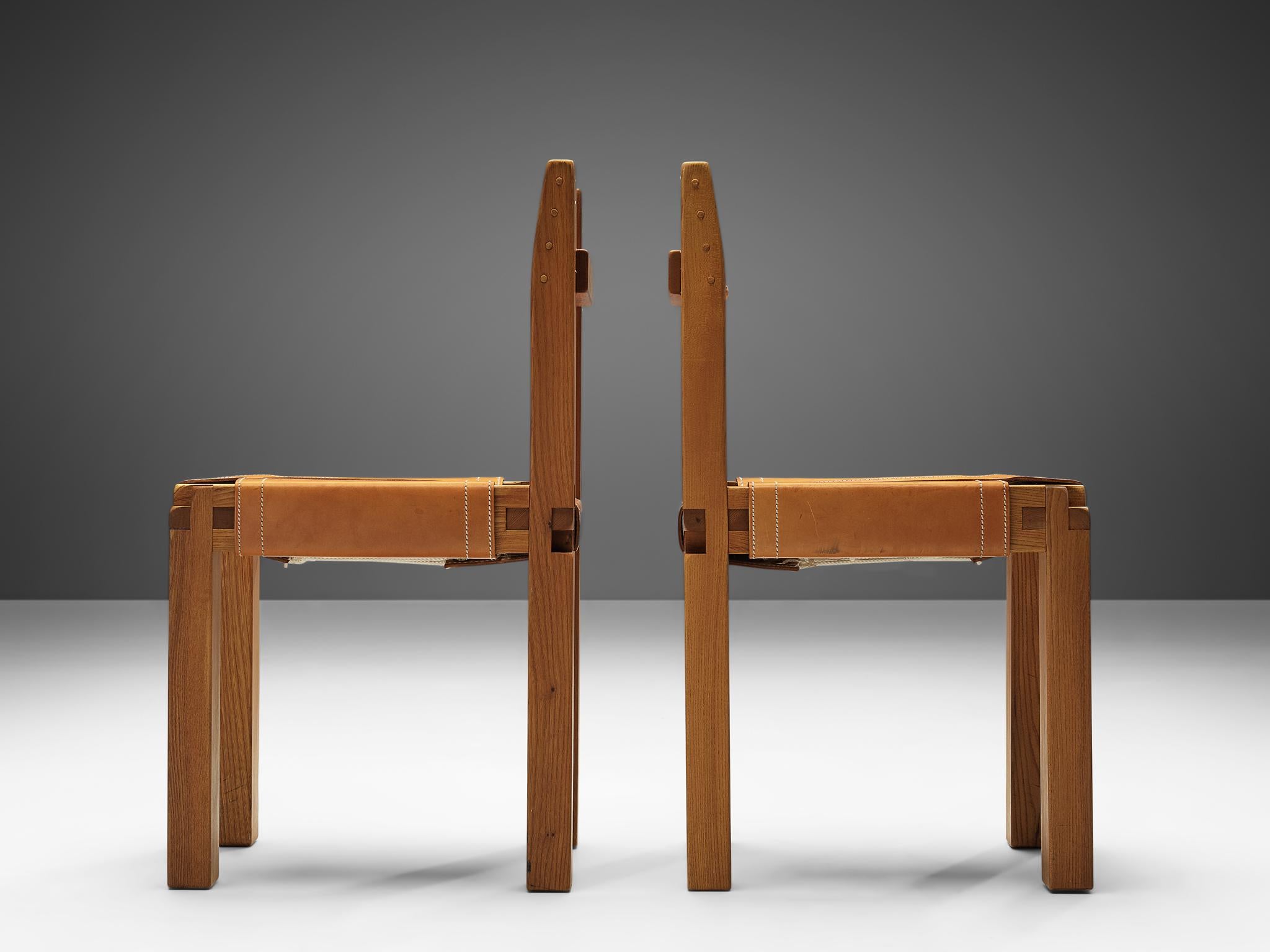 Pierre Chapo, pair of dining chairs, model S11, elm and leather, France, circa 1966.

A pair of chairs in solid elmwood with cognac leather seating and back, designed by French designer Pierre Chapo. These chairs have a cubic design of solid