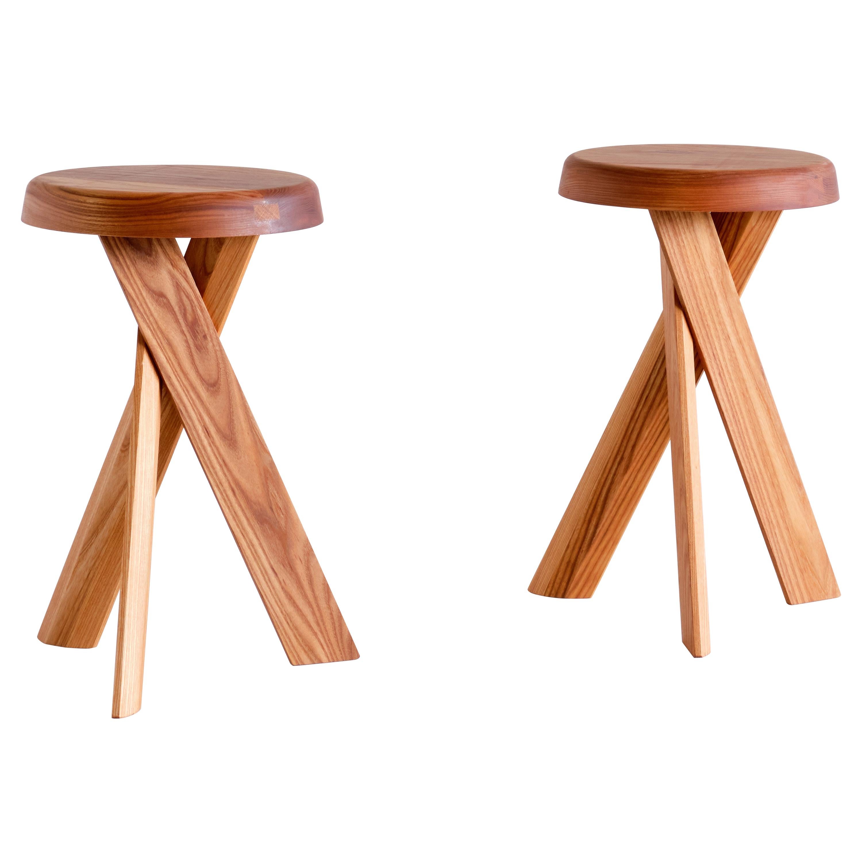 This striking three-legged stool is the model S31 designed by Pierre Chapo in 1974. The cross legged base and round seat are in solid elm wood. This stool also (could work) works well as a small side table.

This new stool was made by Chapo