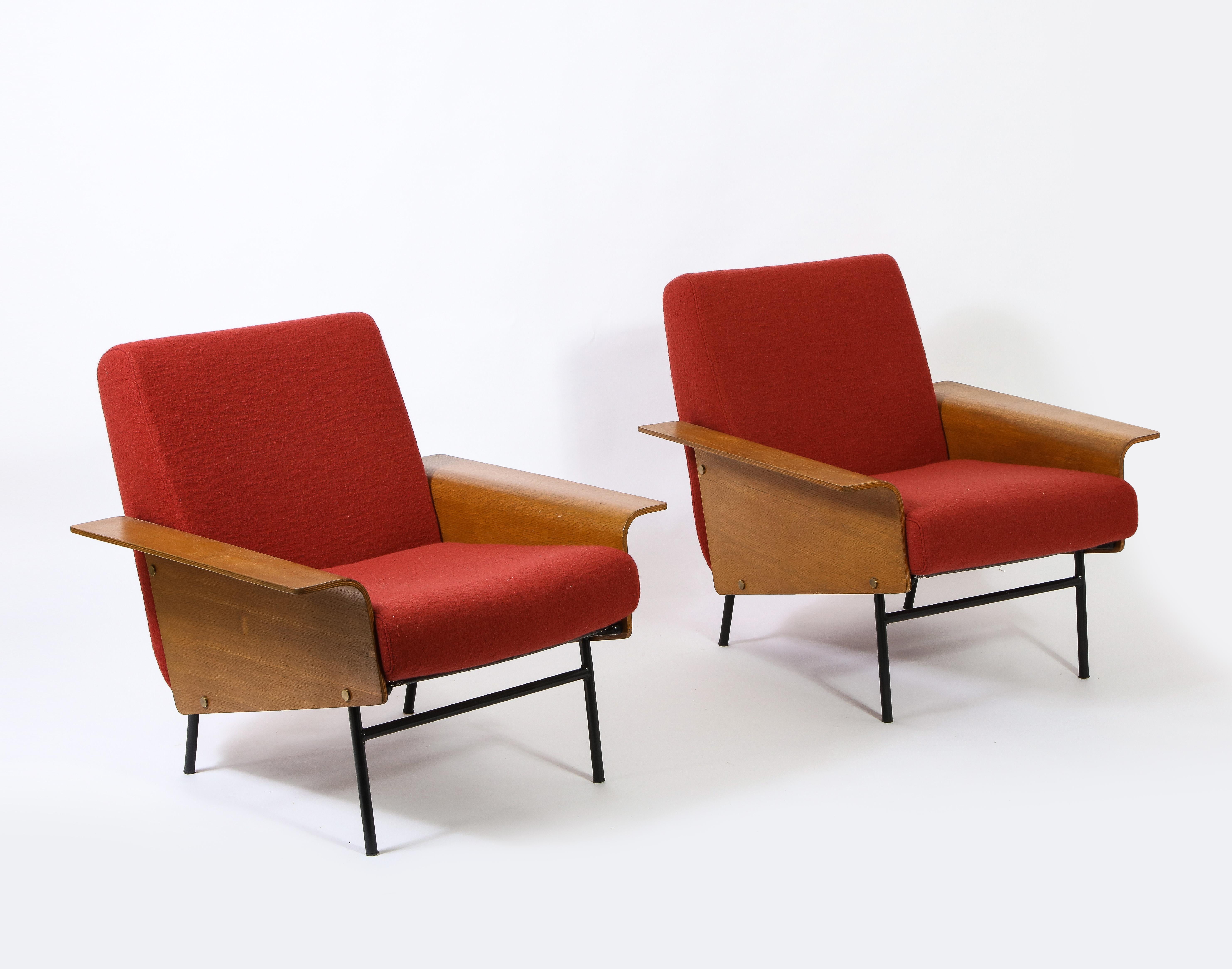 A rare pair of G10 armchairs by Pierre Guariche for Airborne. Newly upholstered in wool, bent plywood arms on an enameled tubular steel frame. Guariche is the quintessential French designer. His forms are defined by simple lines and strong elegance.
