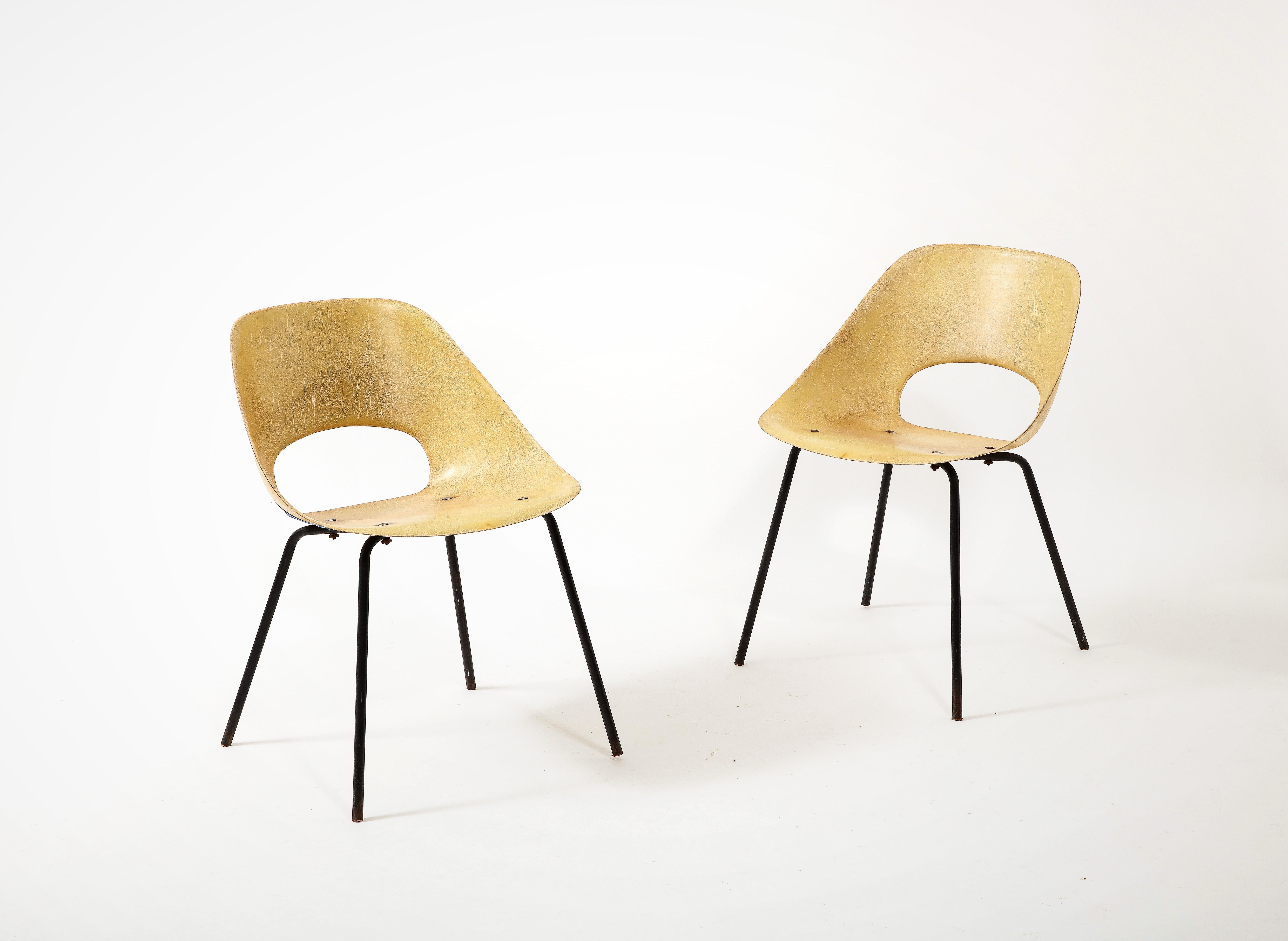 Rare pair of yellow fiberglass side chairs by Pierre Guariche in good vintage. These 