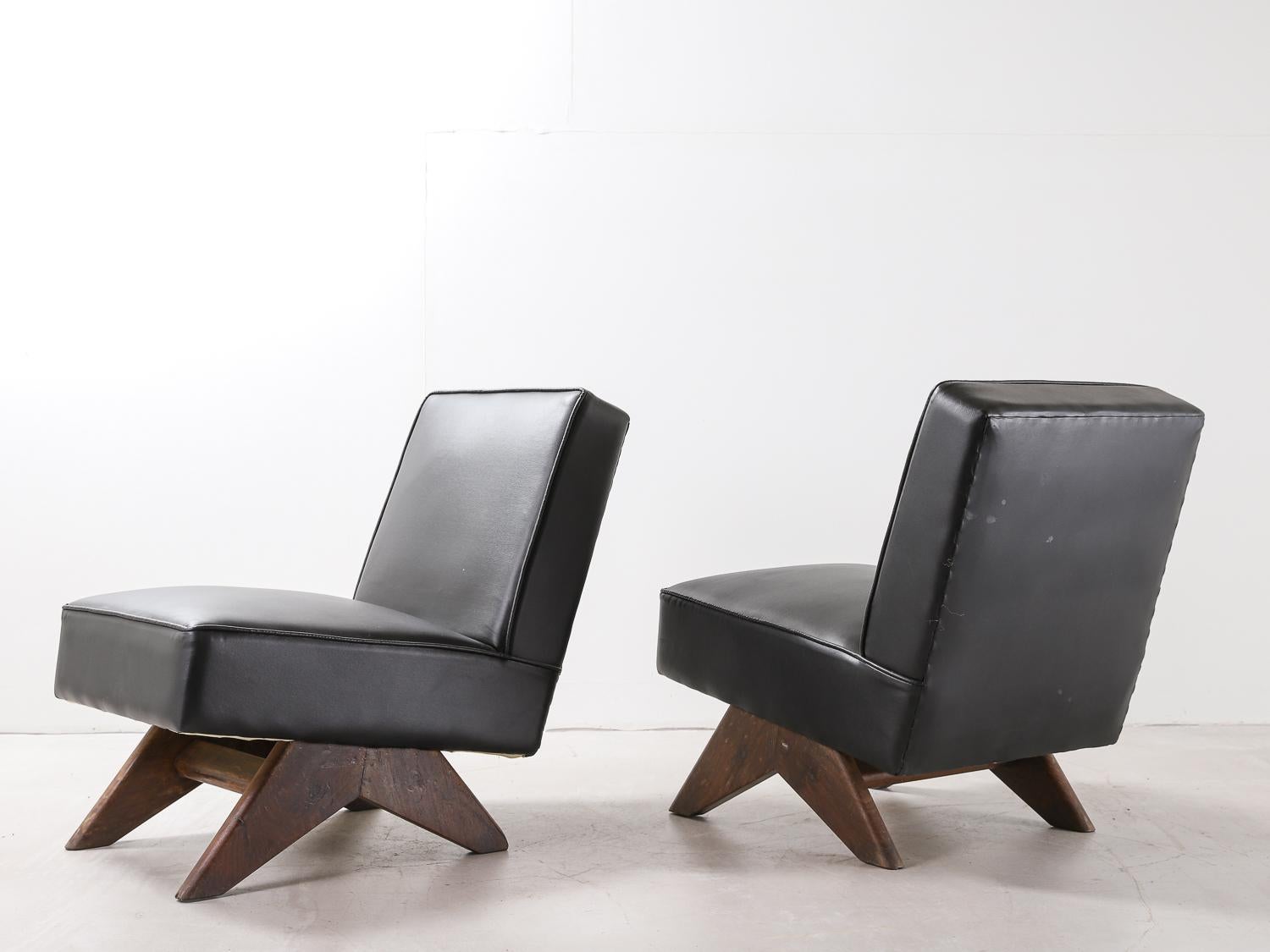 Pair of Pierre Jeanneret “Fireside” chair, circa 1955-1956. Teak and faux leather. Intended for; High court and University of Punjab, Chandigarh, India

Photos include chairs in original condition before being restored.