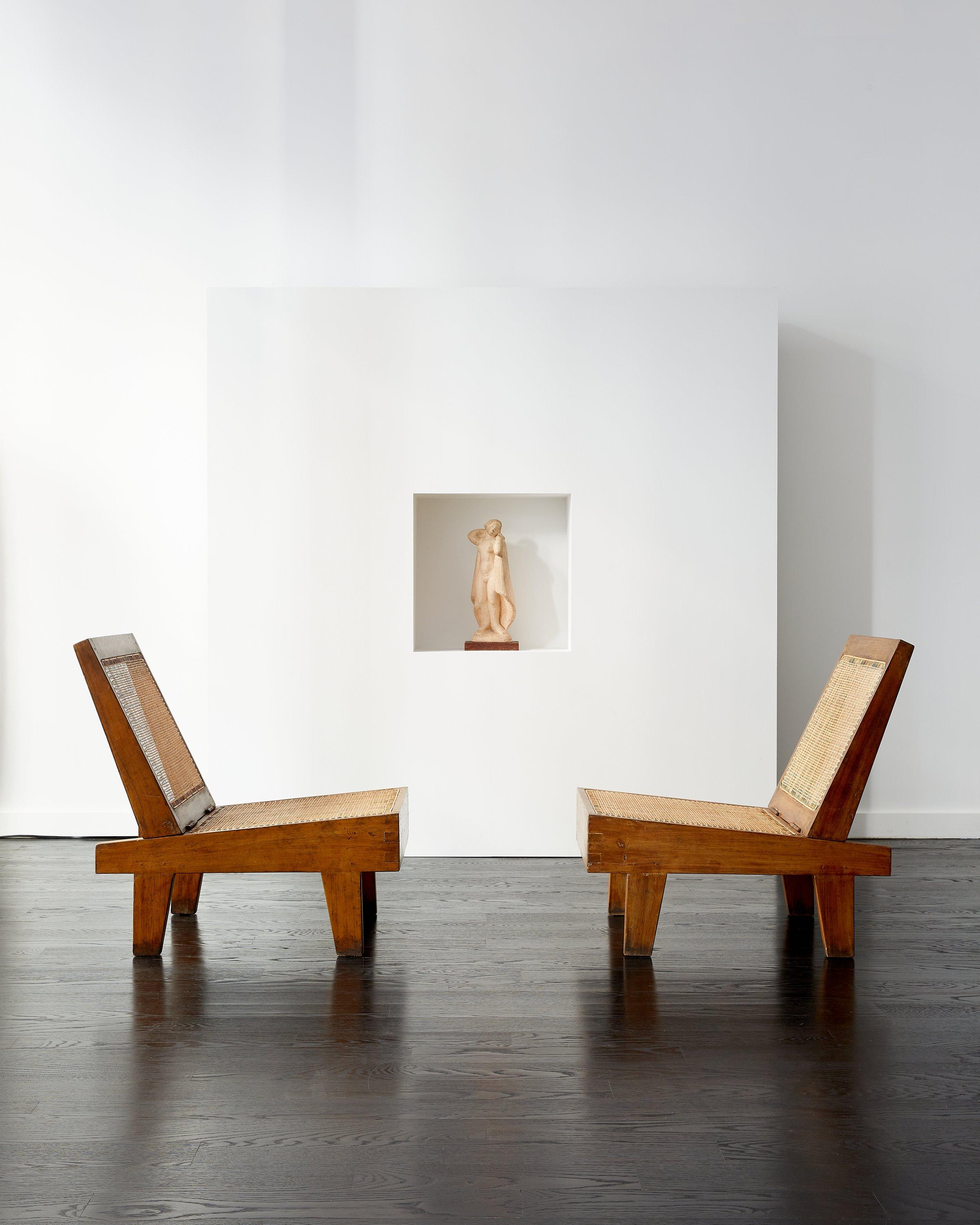 Pair of Pierre Jeanneret folding low chairs.

Chandigarh, India c. 1960.

Solid teak, braided cane.

Designed for private residences in Chandigarh.

Lightly conserved and re-caned by M.S, New York.

Measurements: 28 1/8” depth, 21