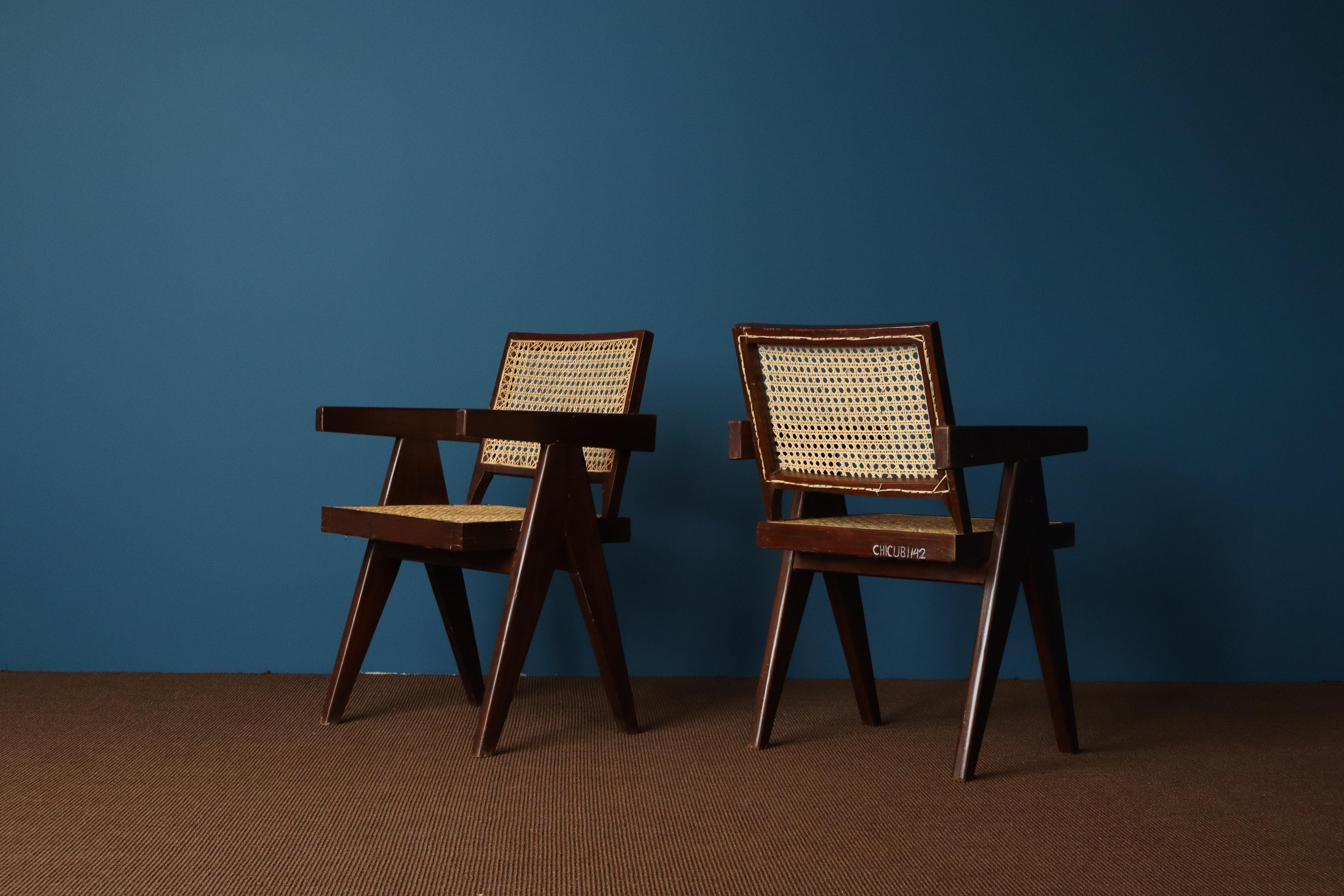 A rare pair of office armchairs designed by Pierre Jeanneret for the Chandigarh administrative buildings, circa 1955-1960.

With their solid teak frames, angular compass-style legs, and flat armrests, these chairs reflect Jeanneret’s clear and