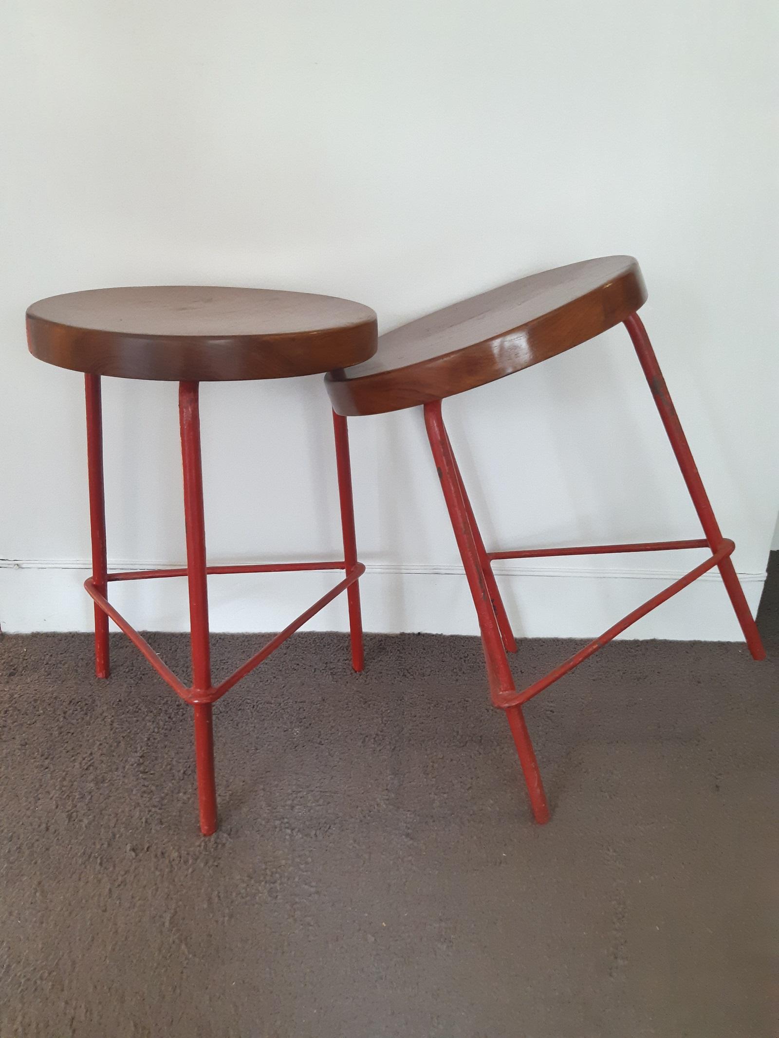 Pair of Pierre Jeanneret stools from the College of Architecture in Chandigarh, India.
Base in red lacquered metal and seat in teak.
D33cm, H48cm.

Price is for one stool