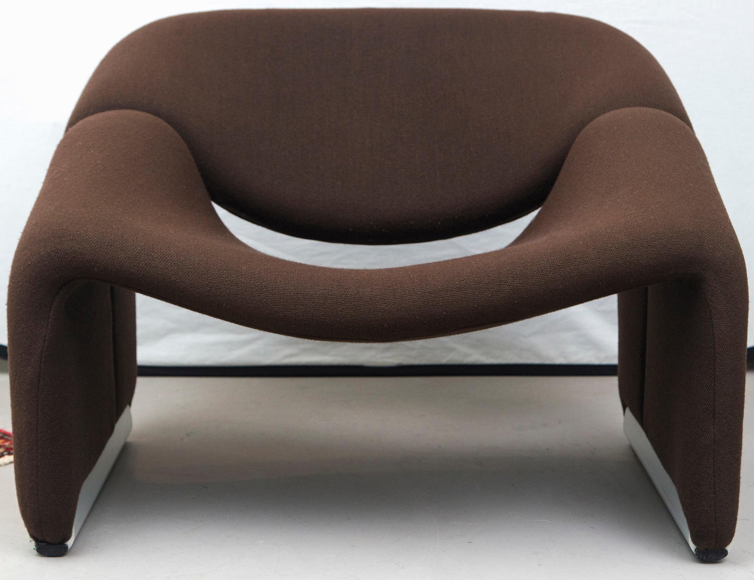 The Groovy chair, or F598, was designed in 1973 by France's top designer Pierre Paulin for Holland's most Avant Garde furniture maker Artifort.

This pair sits on silver colored feet and is upholstered with a brown woollen fabric.