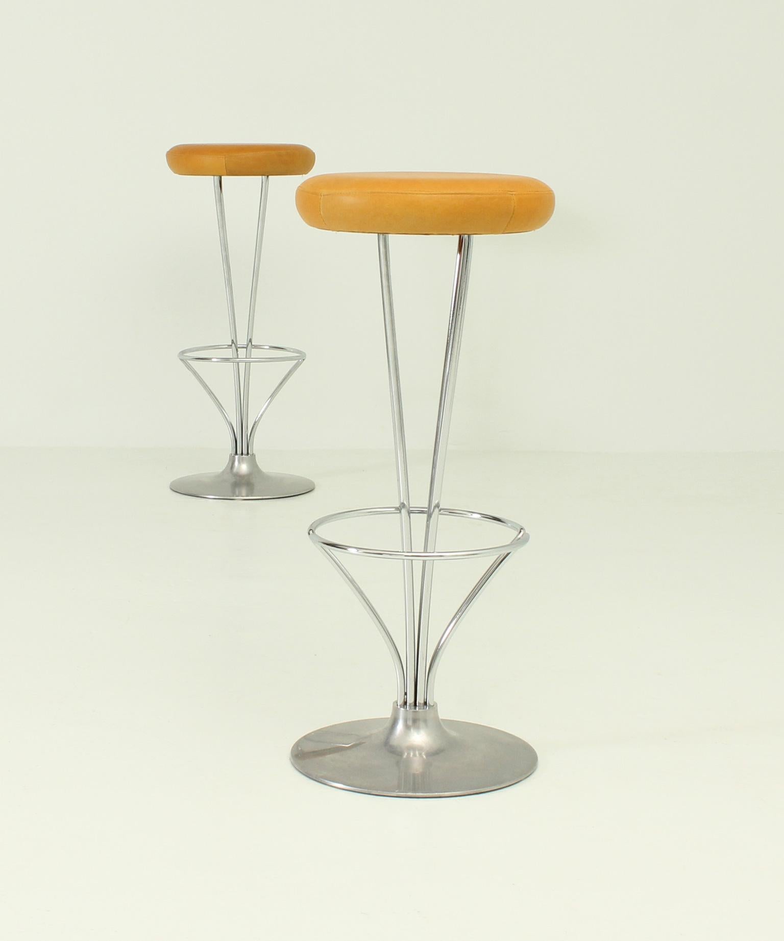 Pair of stools designed in 1968 by Piet Hein as part of the Superellipse table series for Fritz Hansen, Denmark. Chromed and brushed steel bases and leather seats.