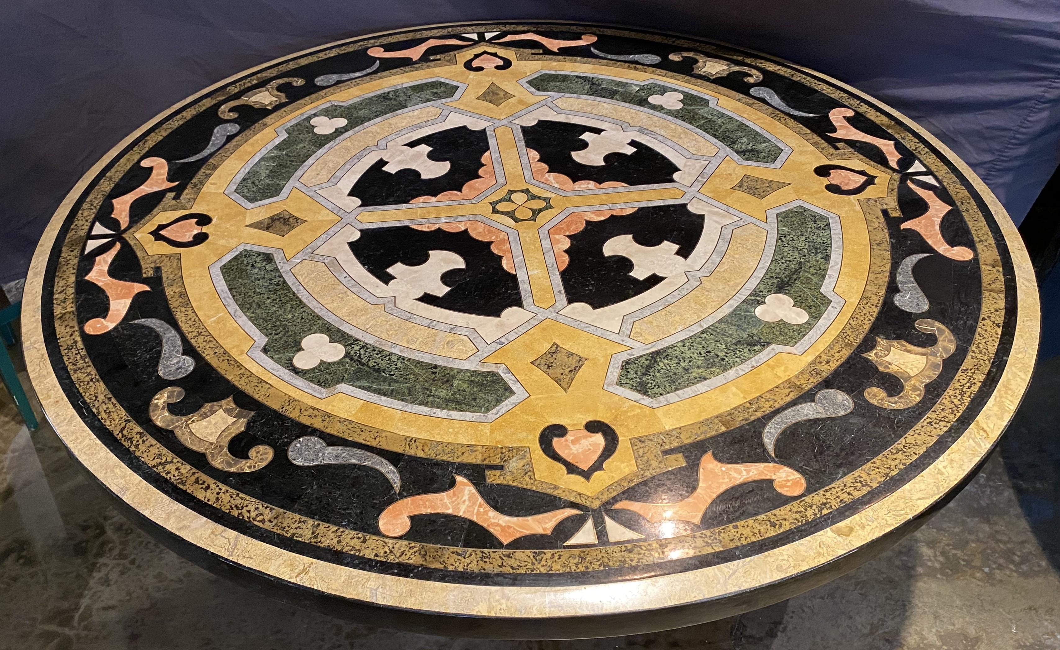 A stunning pair of pedestal tables with pietra dura stone veneer & brass inlay round tops on shaped composition bases, with contrasting scroll and geometric designs, loosely mounted on baluster form scroll decorated bases with square iron plates.